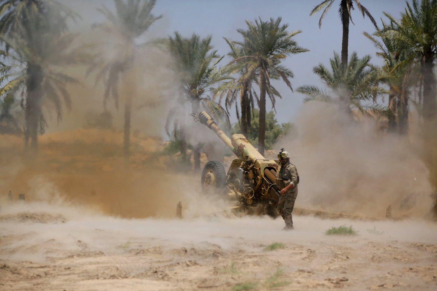 Iraqi security forces fire artillery during clashes with Sunni militant group Islamic State of Iraq and Syria (ISIS) in Jurf al-Sakhar June 14.