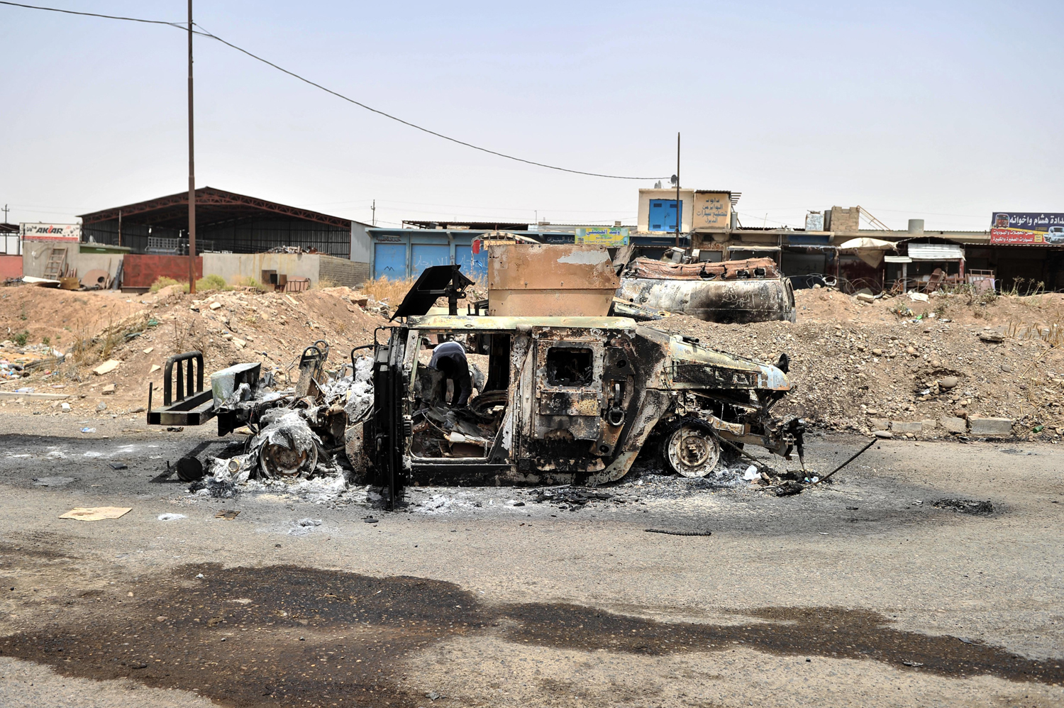 An Iraq army vehicle is seen burned by militants in Mosul, on June 12, 2014.