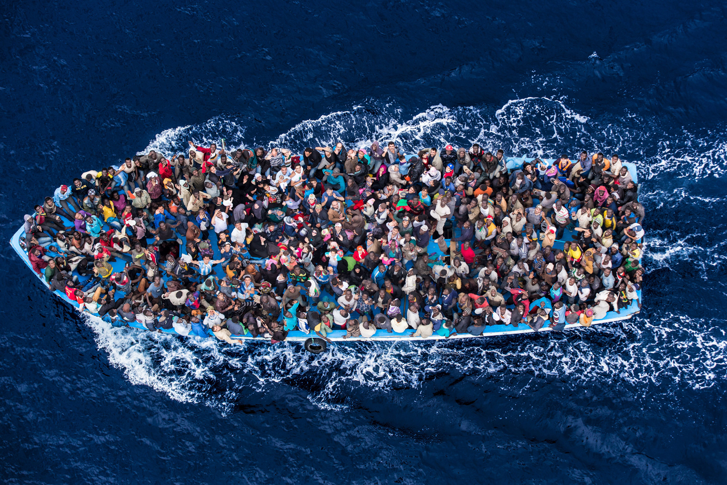 Italian navy rescues asylum seekers traveling by boat off the coast of Africa in the Mediterranean Sea, June 7, 2014.