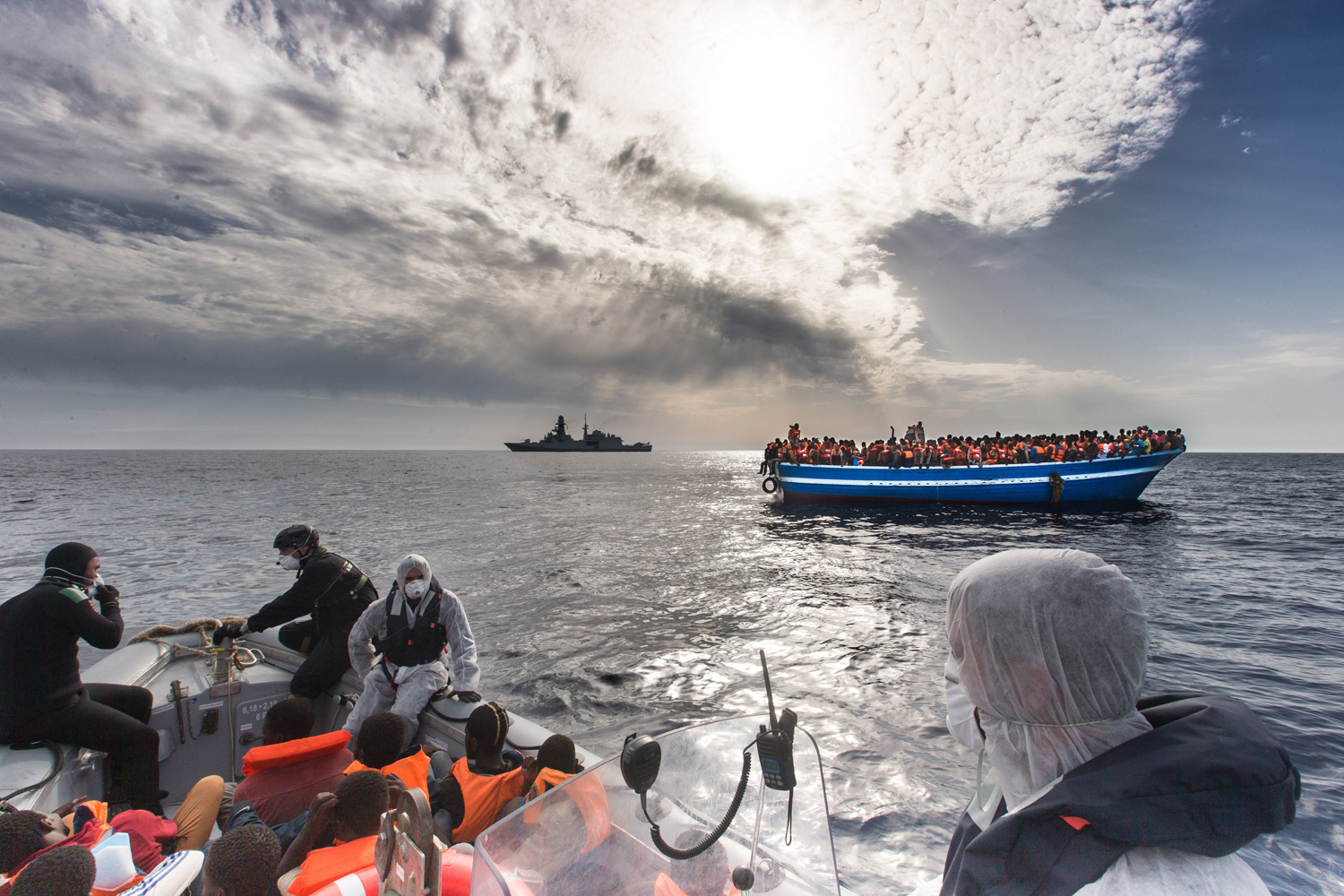 Refugees rescued off a boat and carried onto an Italian navy ship on the Mediterranean Sea, June 7.