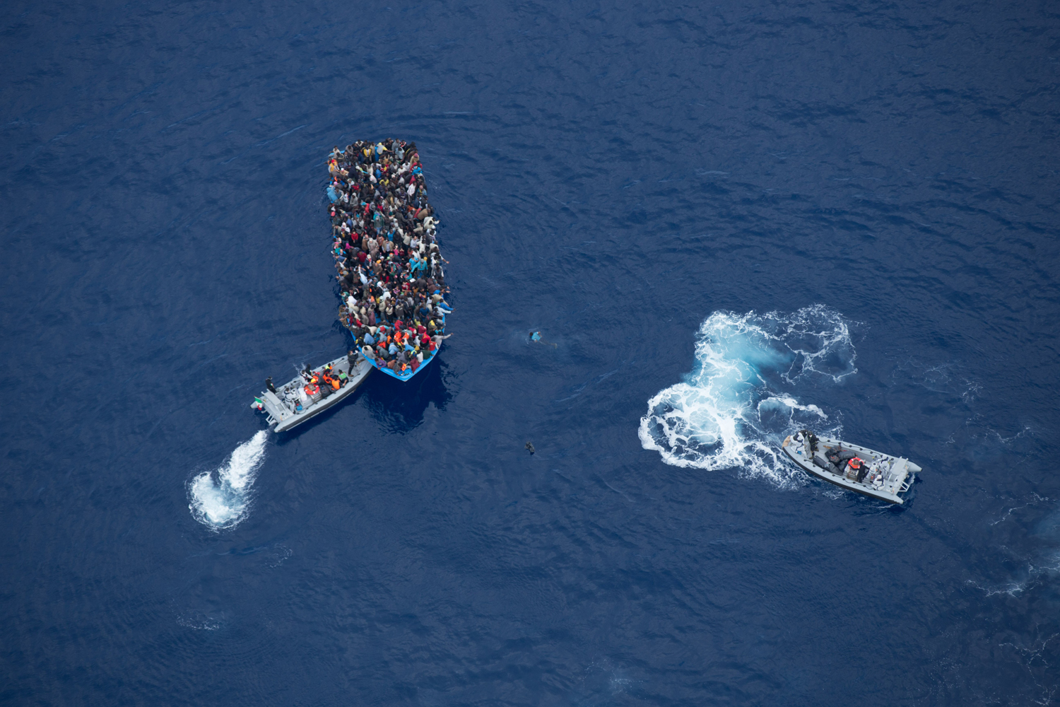 Italian navy rescues asylum seekers traveling by boat off the coast of Africa, June 7.