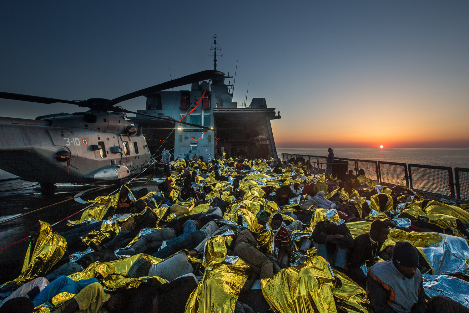 African asylum seekers rescued off boats and taken aboard an Italy navy ship, June 8, 2014.