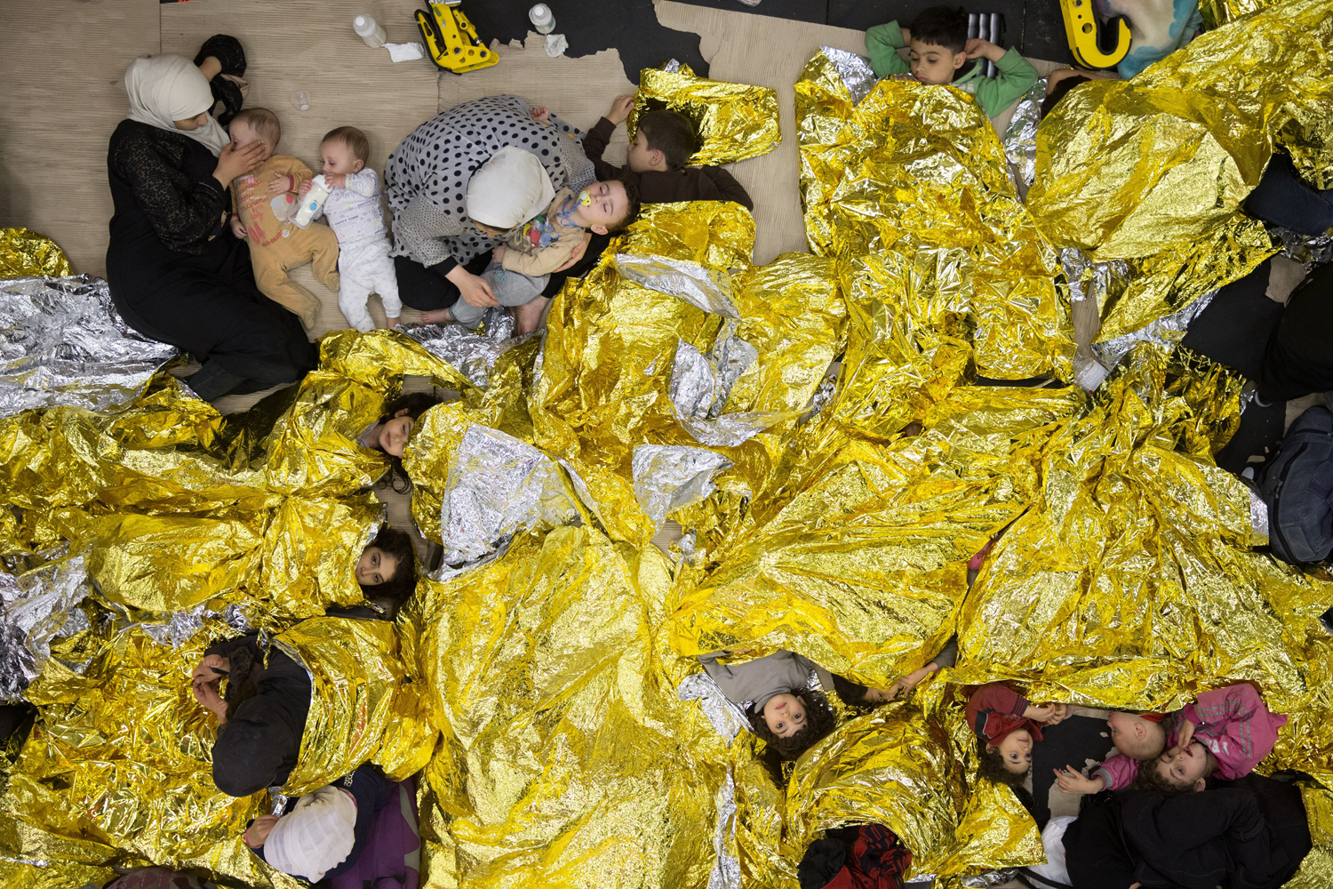 Syrian refugees sleeping on an Italian navy ship after being rescued from a fishing vessel carrying 443 Syrian asylum seekers, June 5, 2014. (Massimo Sestini—Polaris)