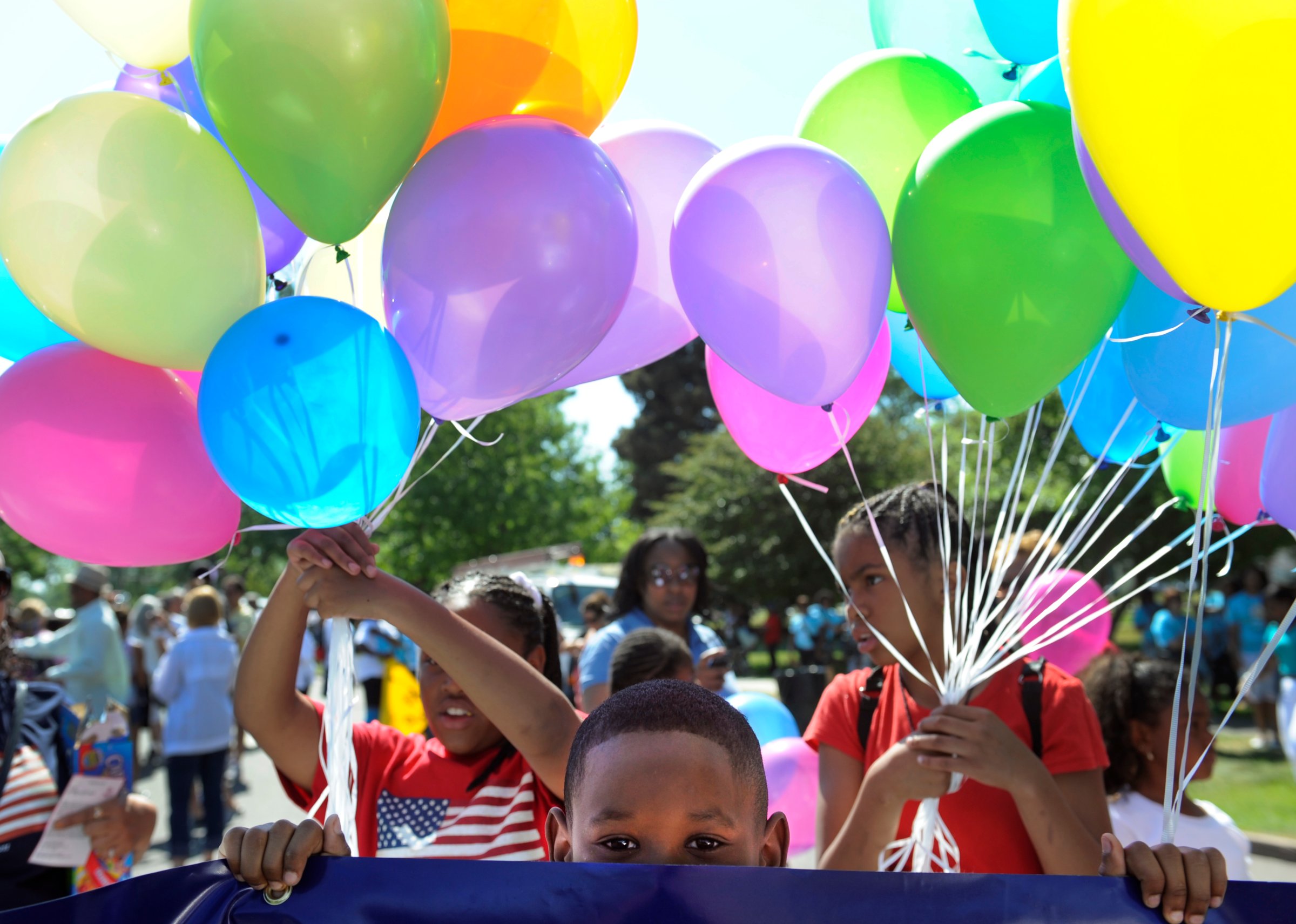 Brian Harris, 8, waits for the parade to begin with his mom and other employees from US Bank. The Friends of Blair Caldwell African American Research Library Foundation hosts the 2011 Denver Juneteenth Celebration: We Define Who We Are, on Saturday, June