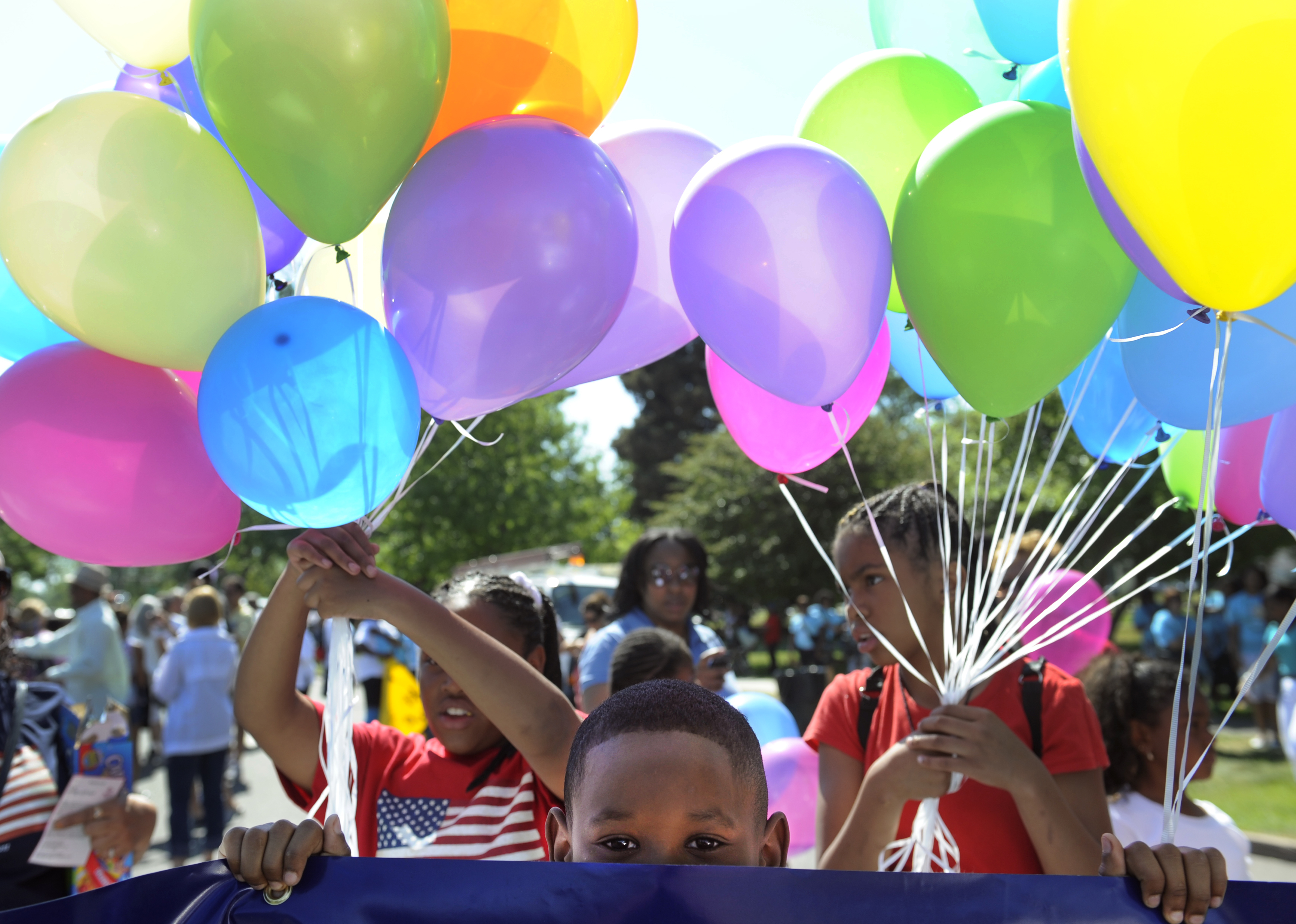 Brian Harris, 8, waits for the Denver Juneteenth parade to begin with his mom and other employees from US Bank in Denver on June 18, 2011. (Kathryn Scott Osler—Denver Post/Getty Images)
