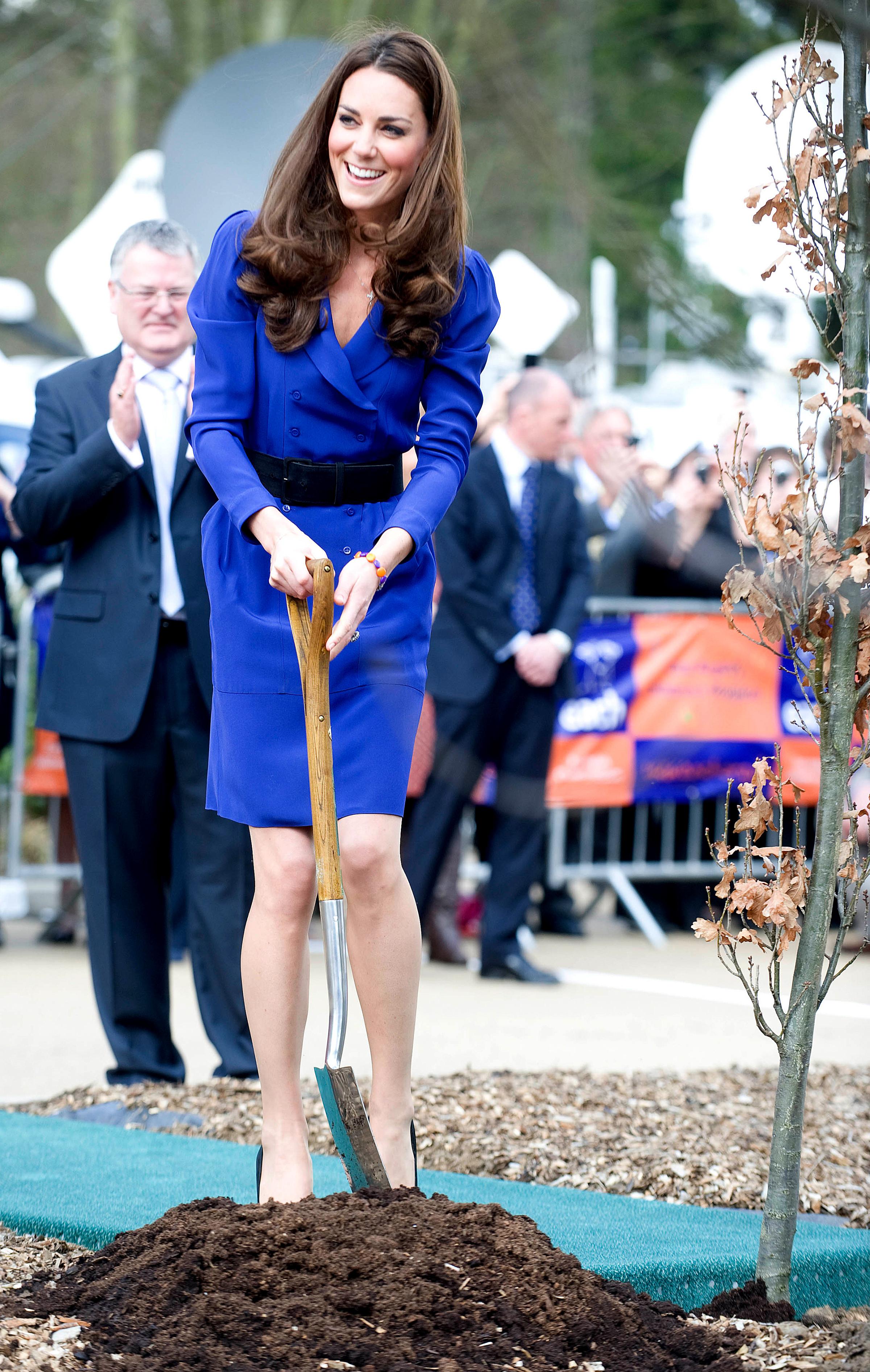 Britain's Catherine, Duchess of Cambridge plants a tree during a visit to The Treehouse in Ipswich, England, on March 19, 2012.