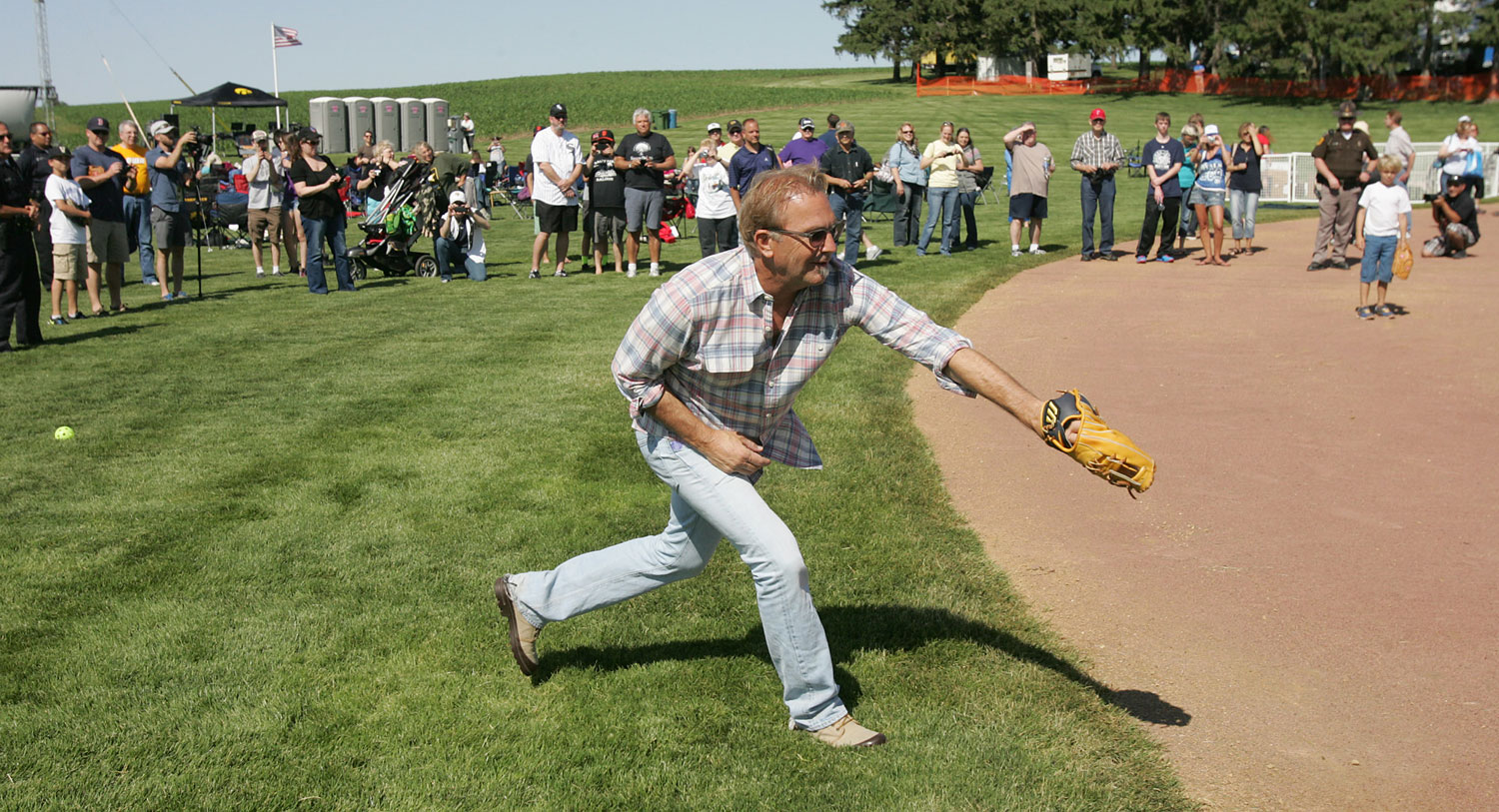 Actor Kevin Costner plays catch with his sons during a party celebrating the 25th anniversary of the "Field of Dreams" movie Friday, June 13, 2014, near Dyersville, Iowa. (Dennis Magee&mdash;Waterloo Courier/AP)