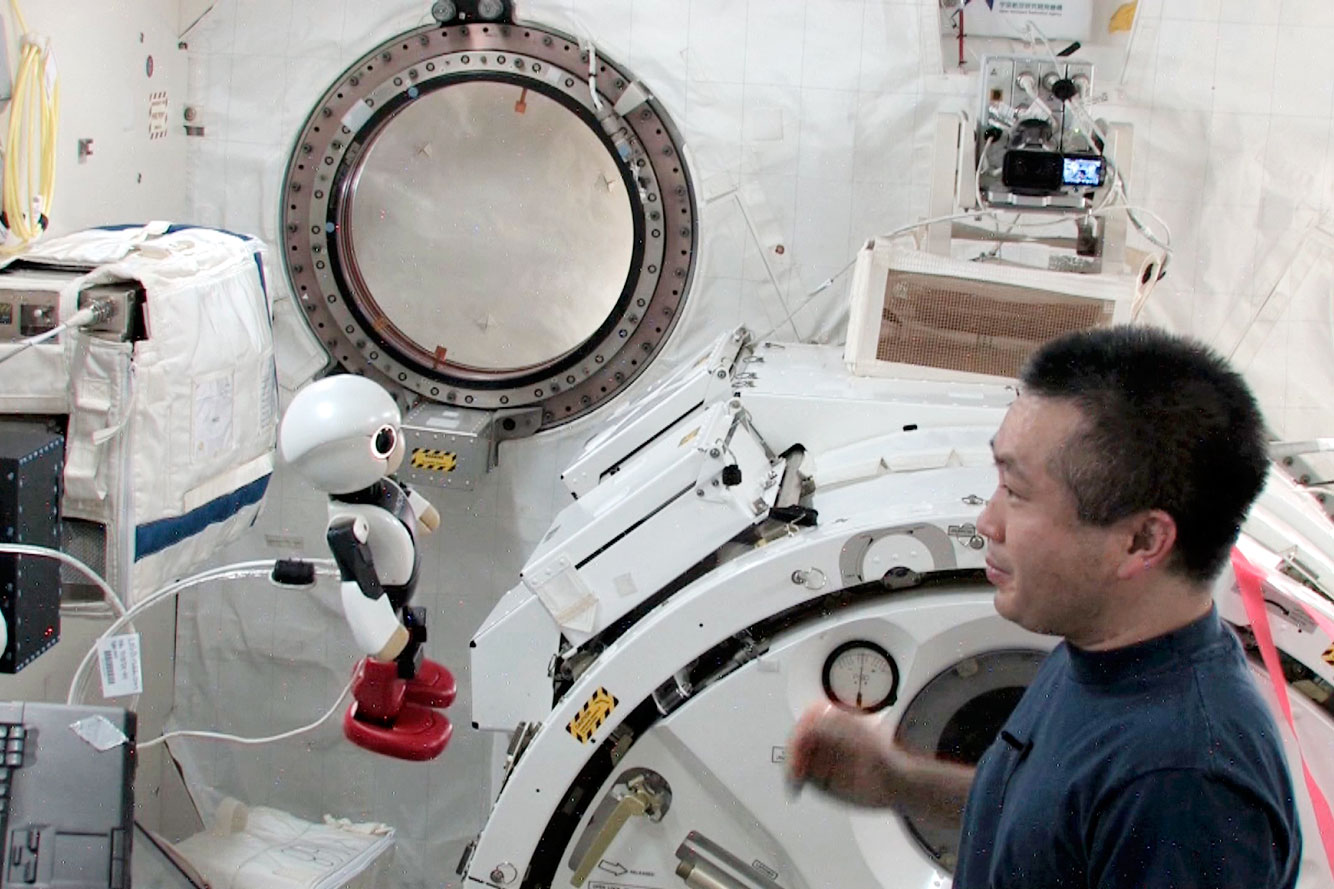 Japanese astronaut Koichi Wakata and Kirobo, a talking humanoid robot, talk at each other on board the International Space Station in this still from a video released on May 13, 2014.