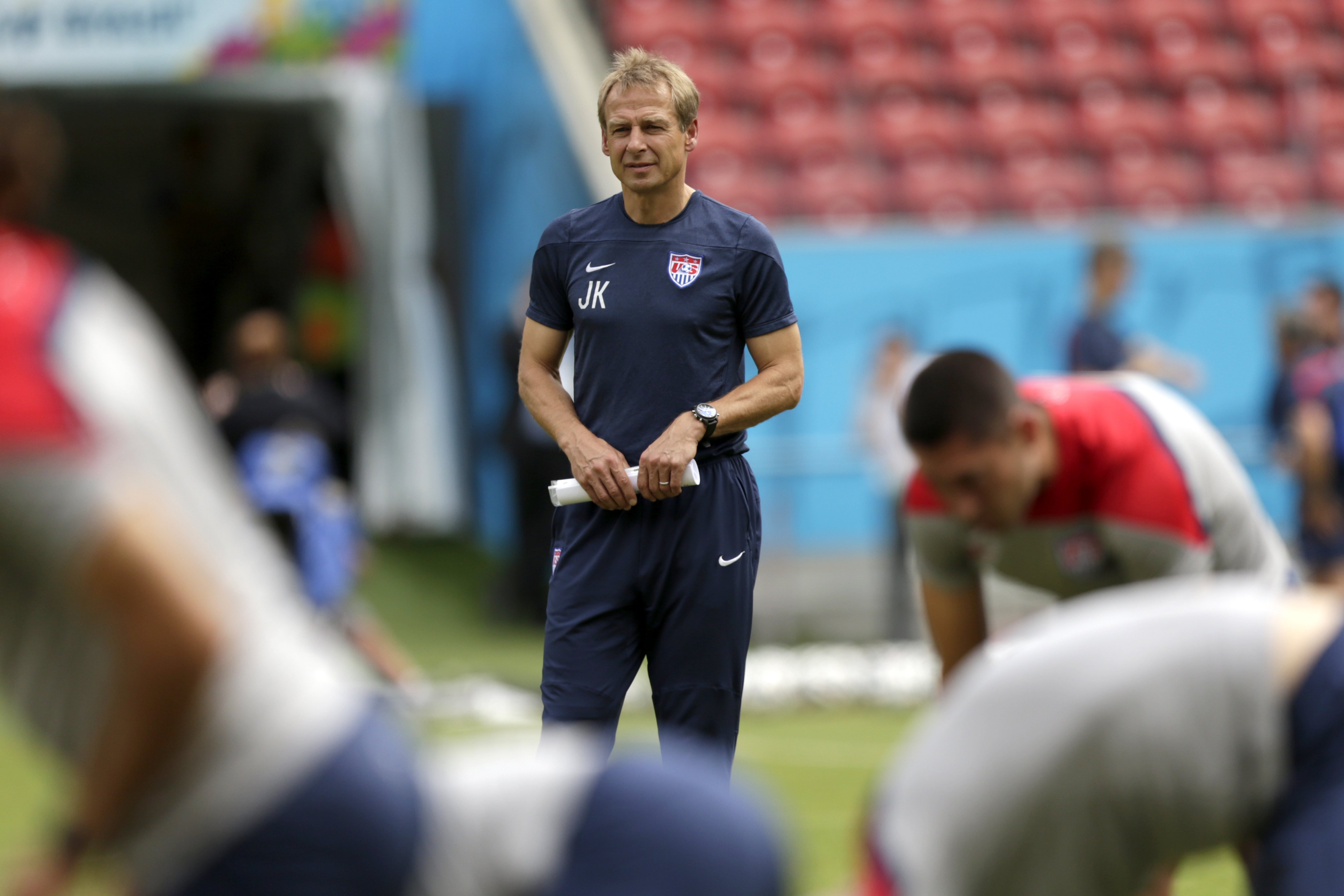 U.S. head coach Jürgen Klinsmann watches as his players stretch during a training session in Recife, Brazil, on June 25, 2014 (Julio Cortez—AP)