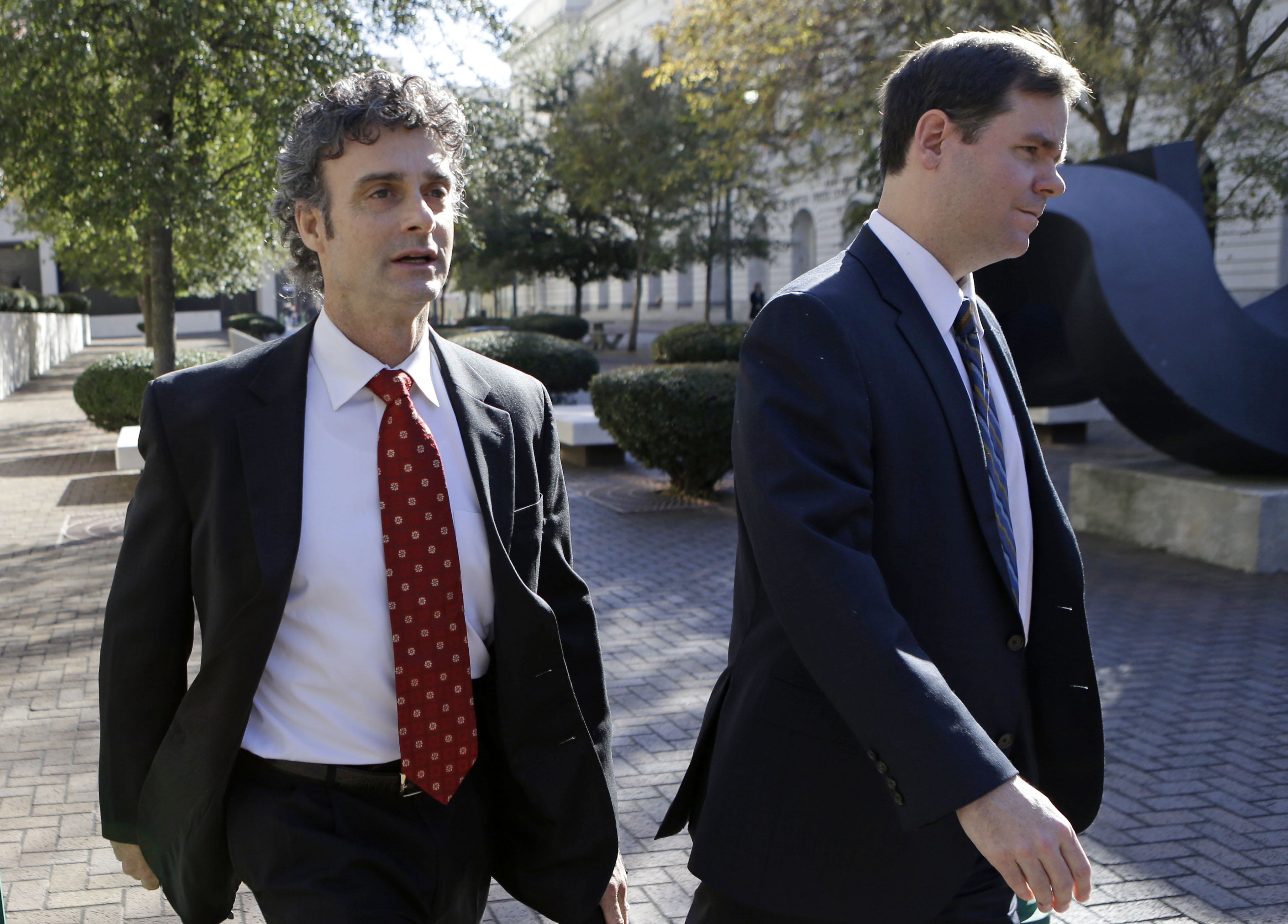 Kurt Mix, left, leaves Federal Court with an unidentified member of his defense team in New Orleans on Dec. 18, 2013. (Gerald Herbert—AP)
