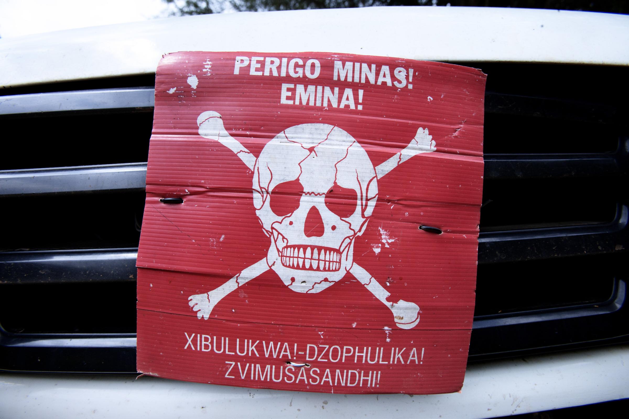 A poster announcing the danger of mines on the front of a Land Rover on June 20, 2014 in Morogoro, Tanzania.