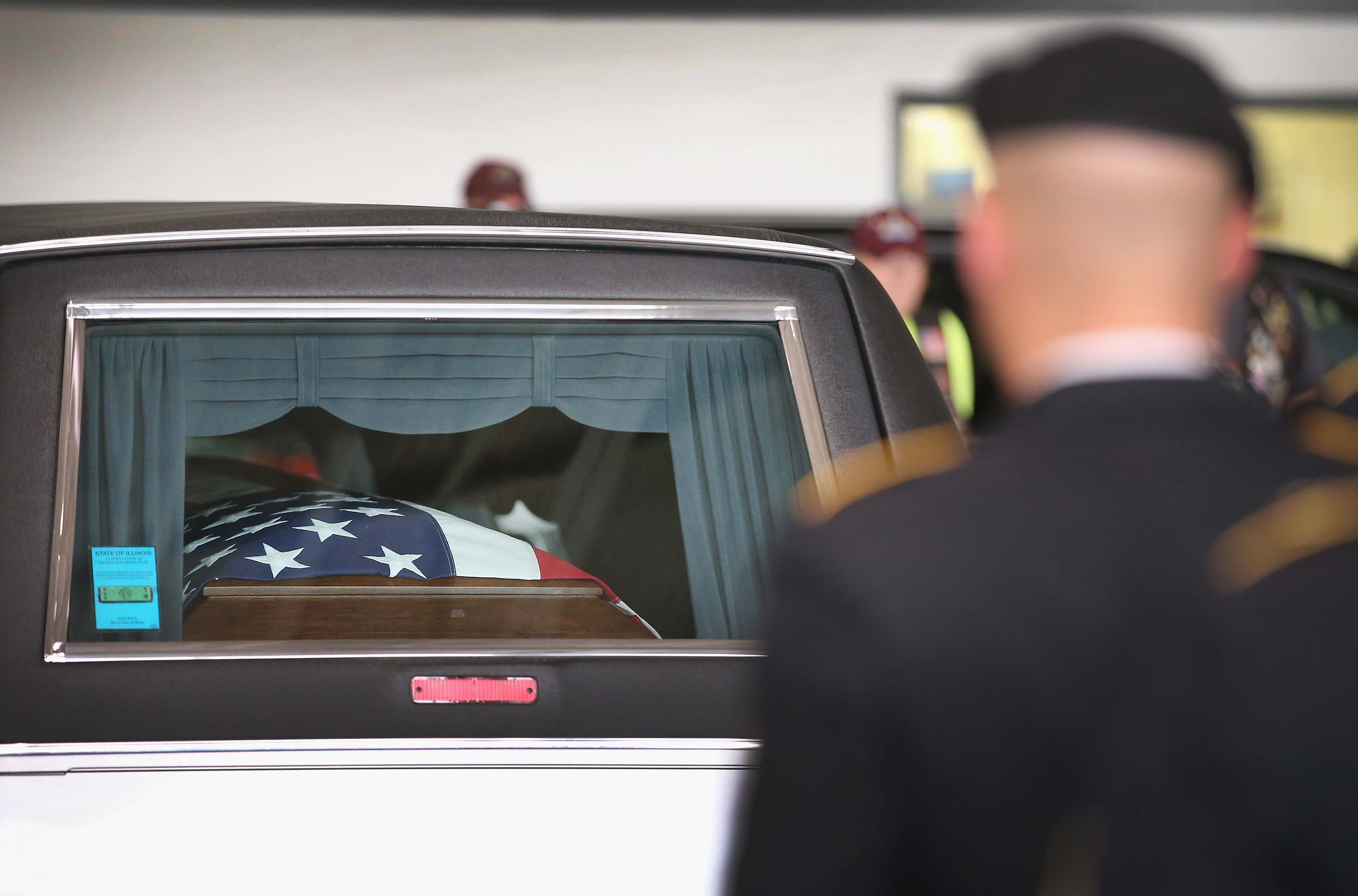 An Army honor guard places the remains of Army Pfc. Aaron Toppen into a hearse at Midway Airport on June 21, 2014 in Chicago.