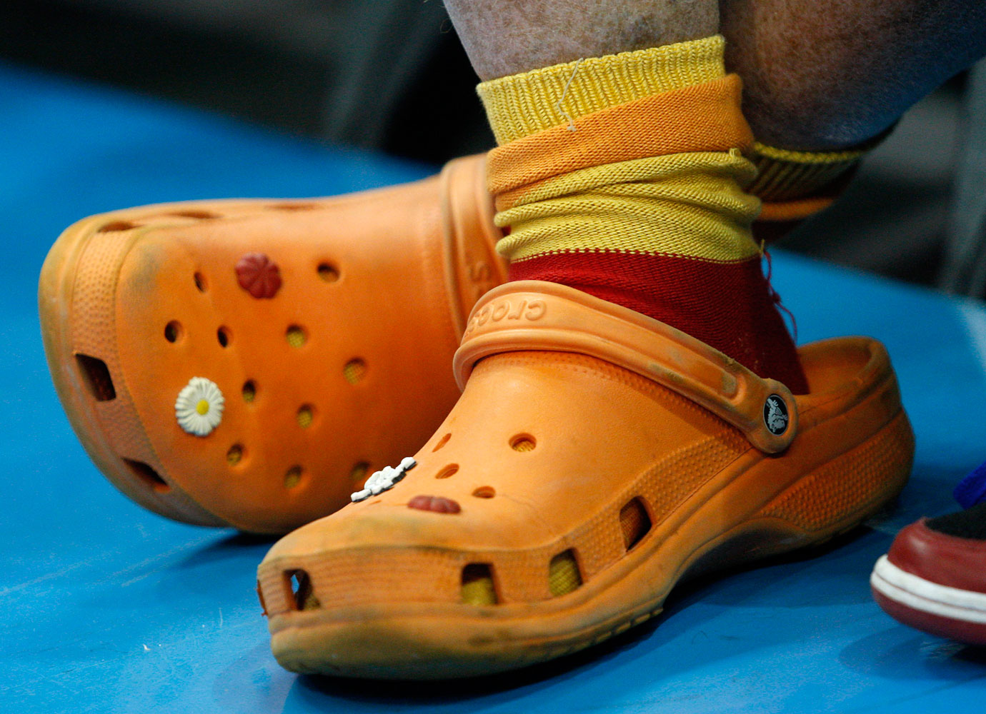 Batali dons dusty, decorated Crocs shoes while watching an NBA basketball game in New Orleans.