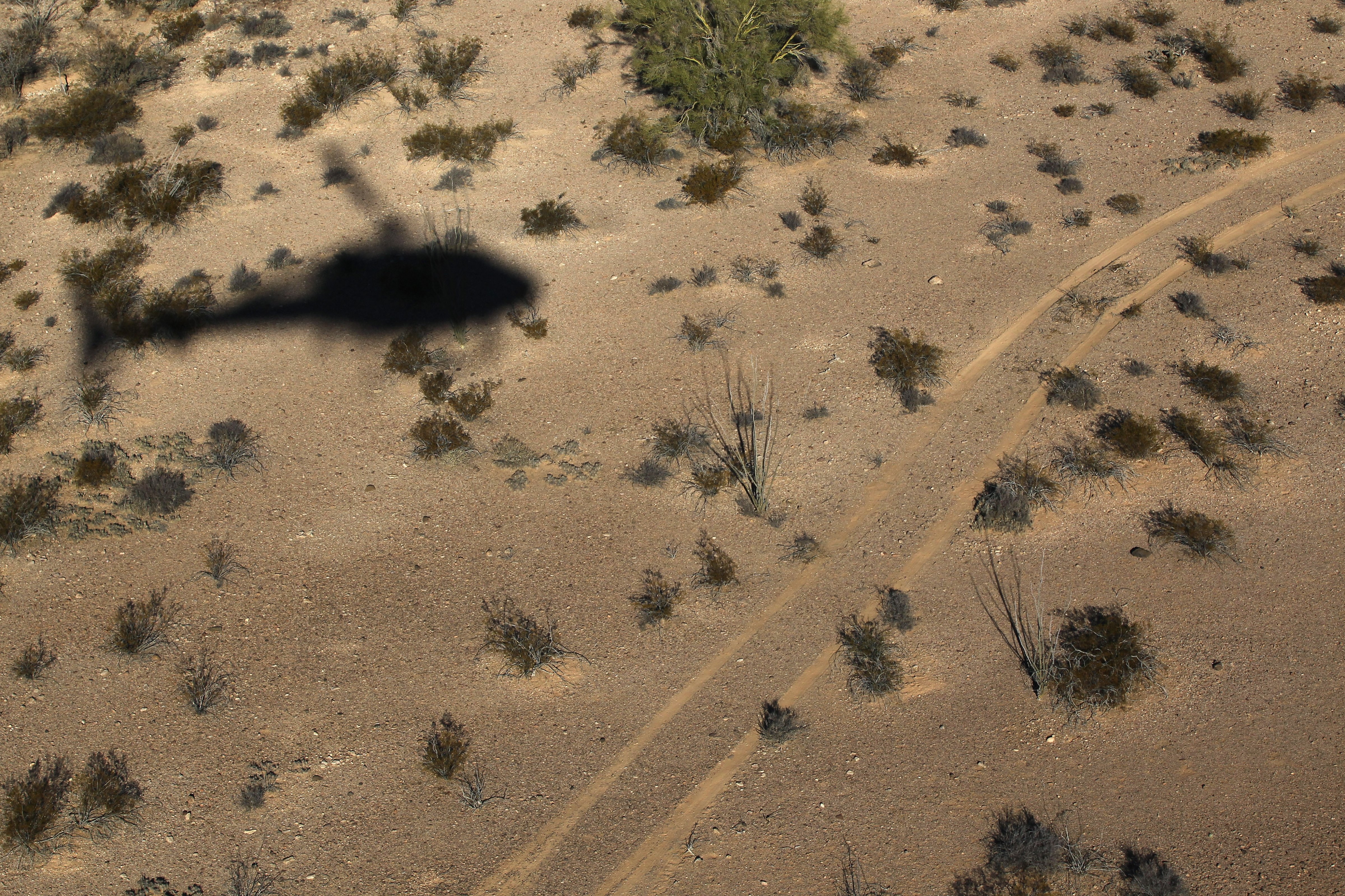 As seen from the air, a helicopter is seen moving north through the Sonoran Desert in Tohono O'odham Nation, Ariz. on December 9, 2010. (John Moore—Getty Images)