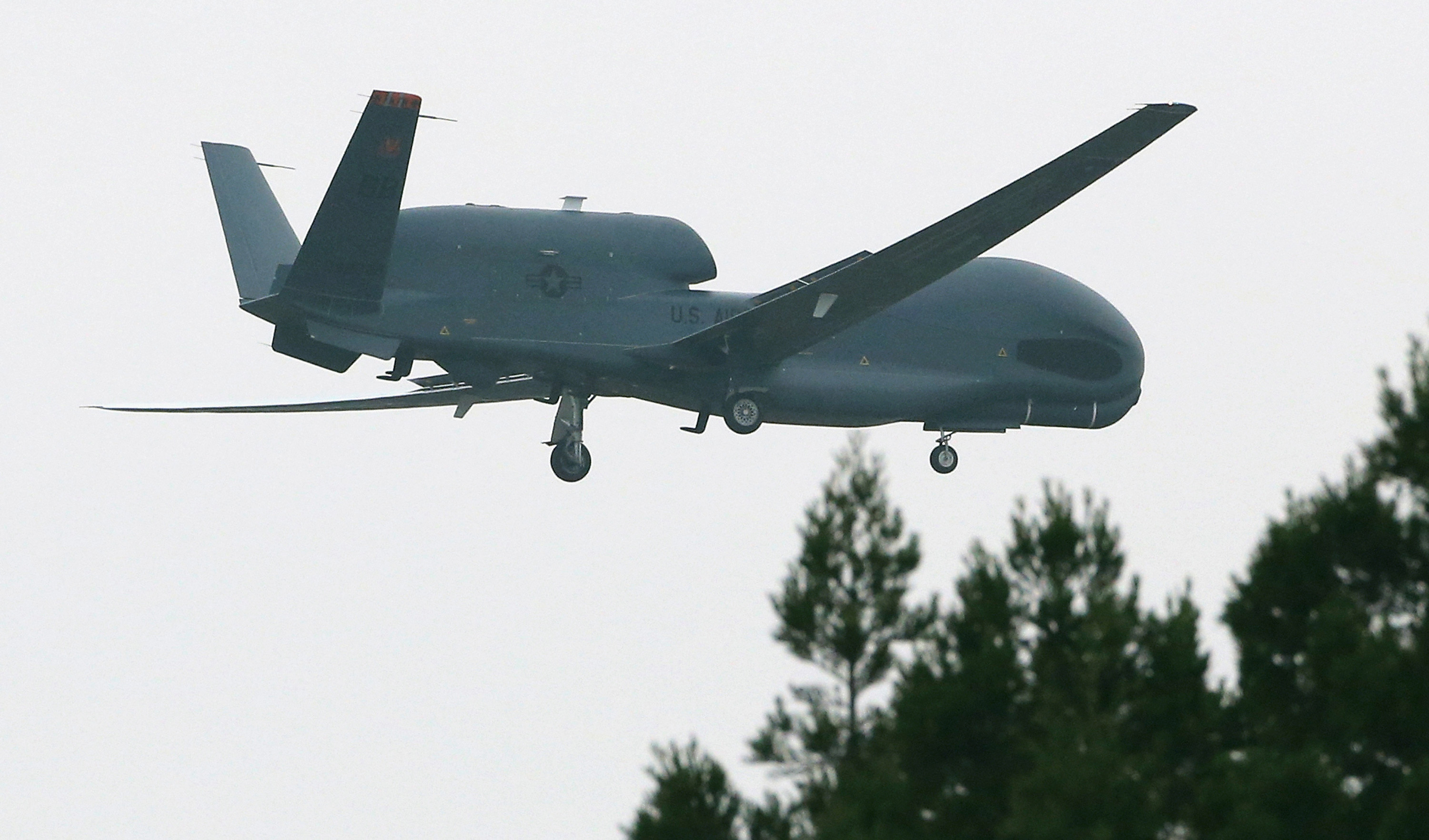 An unmanned surveillance drone 'Global Hawk' flies toward the U.S Misawa Air Base on May 24, 2014 in Misawa, Aomori, Japan. T (The Asahi Shimbun—Getty Images)