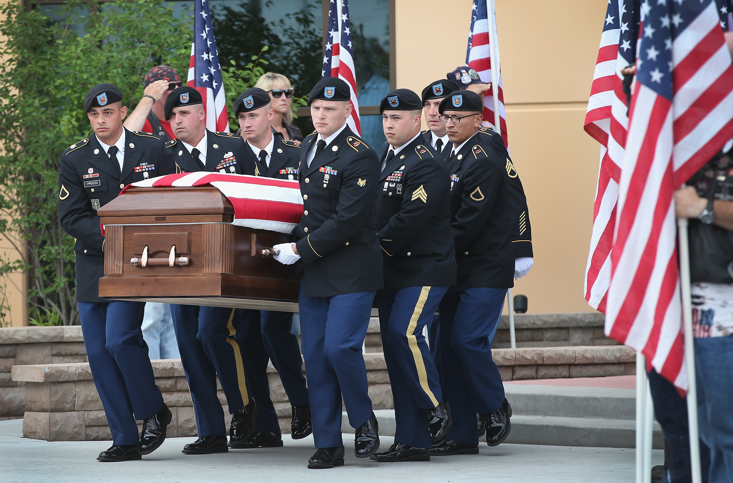 Soldiers carry the casket of U.S. Army Pfc. Aaron Toppen from Parkview Christian Church following his funeral service on June 24, 2014 in Mokena, Ill. (Scott Olson—Getty Images)
