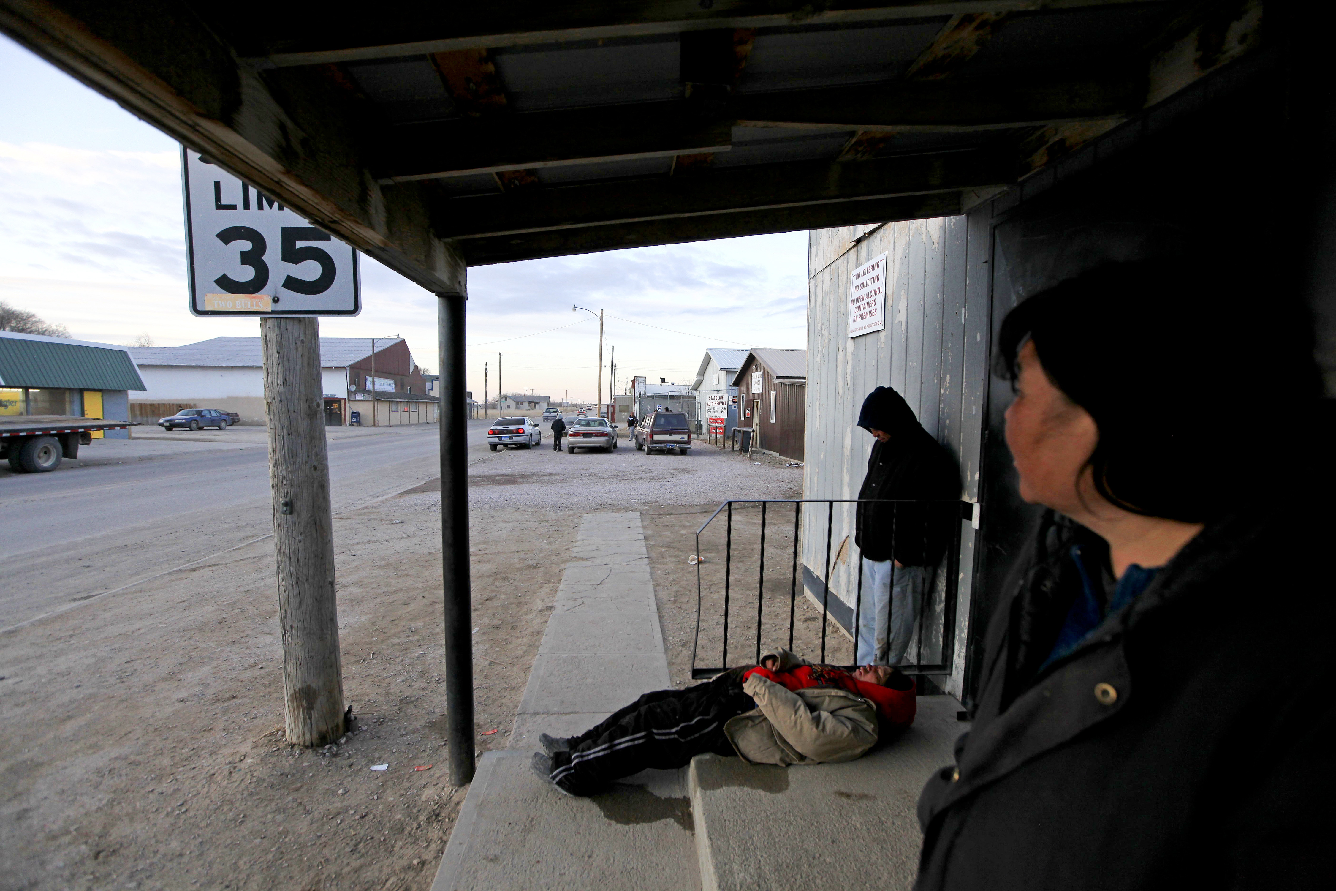 Residents from Pine Ridge Reservation, S.D., in various states of inebriation  outside a store located immediately across the border in Whiteclay, Neb., Feb. 17, 2012.