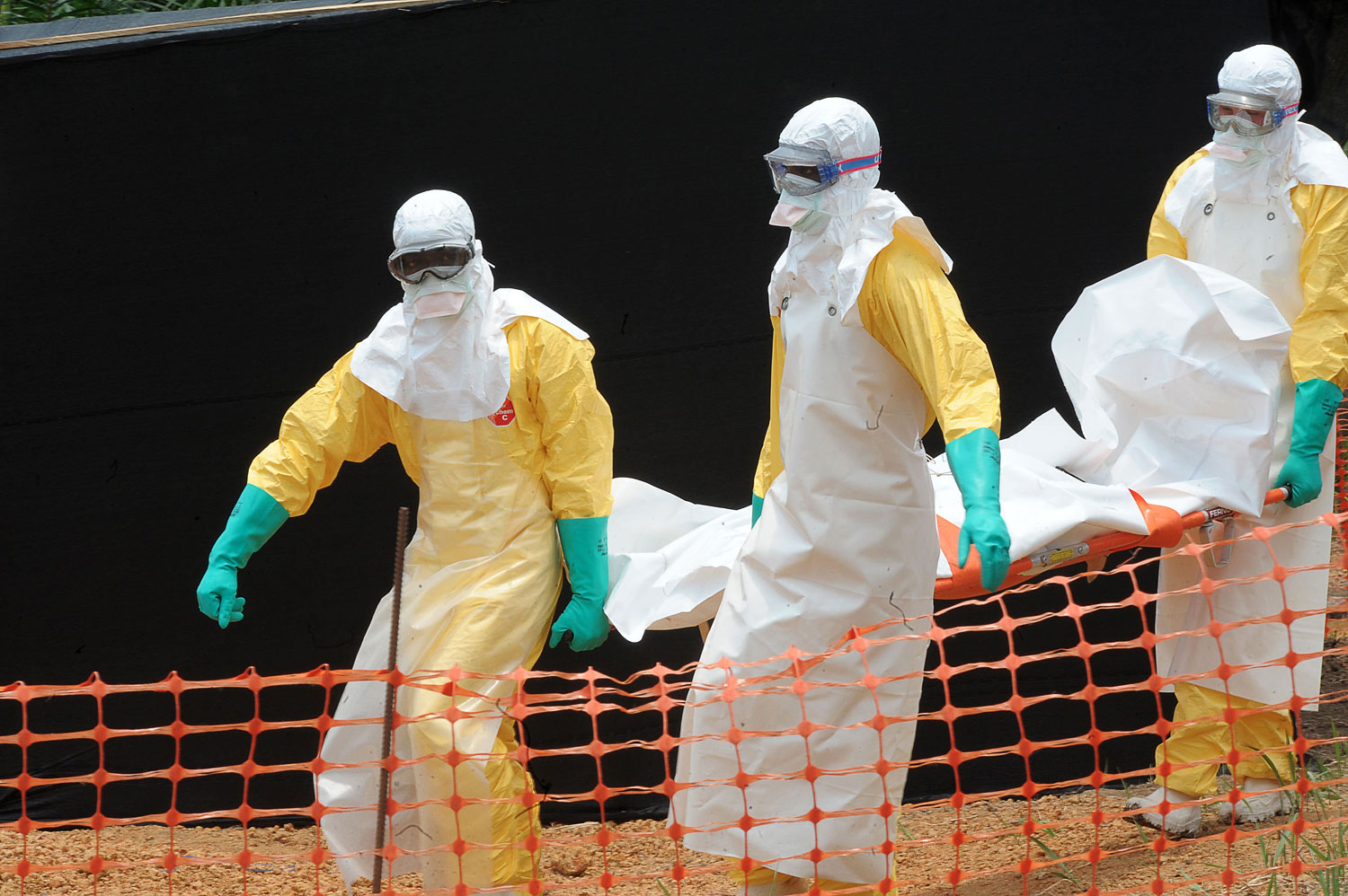 Doctors Without Borders/Médecins Sans Frontières staff carrying the body of a person killed by viral hemorrhagic fever at a center for victims of the Ebola virus in Gueckedou on April 1, 2014.