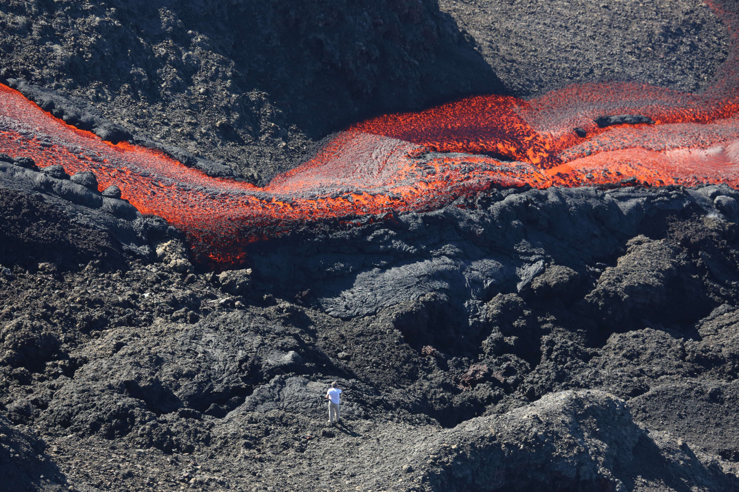 Lava flows out of the Piton de la Fournaise volcano, one of the world's most active volcanoes, located on the French island of La Reunion in the Indian Ocean, June 21, 2014.