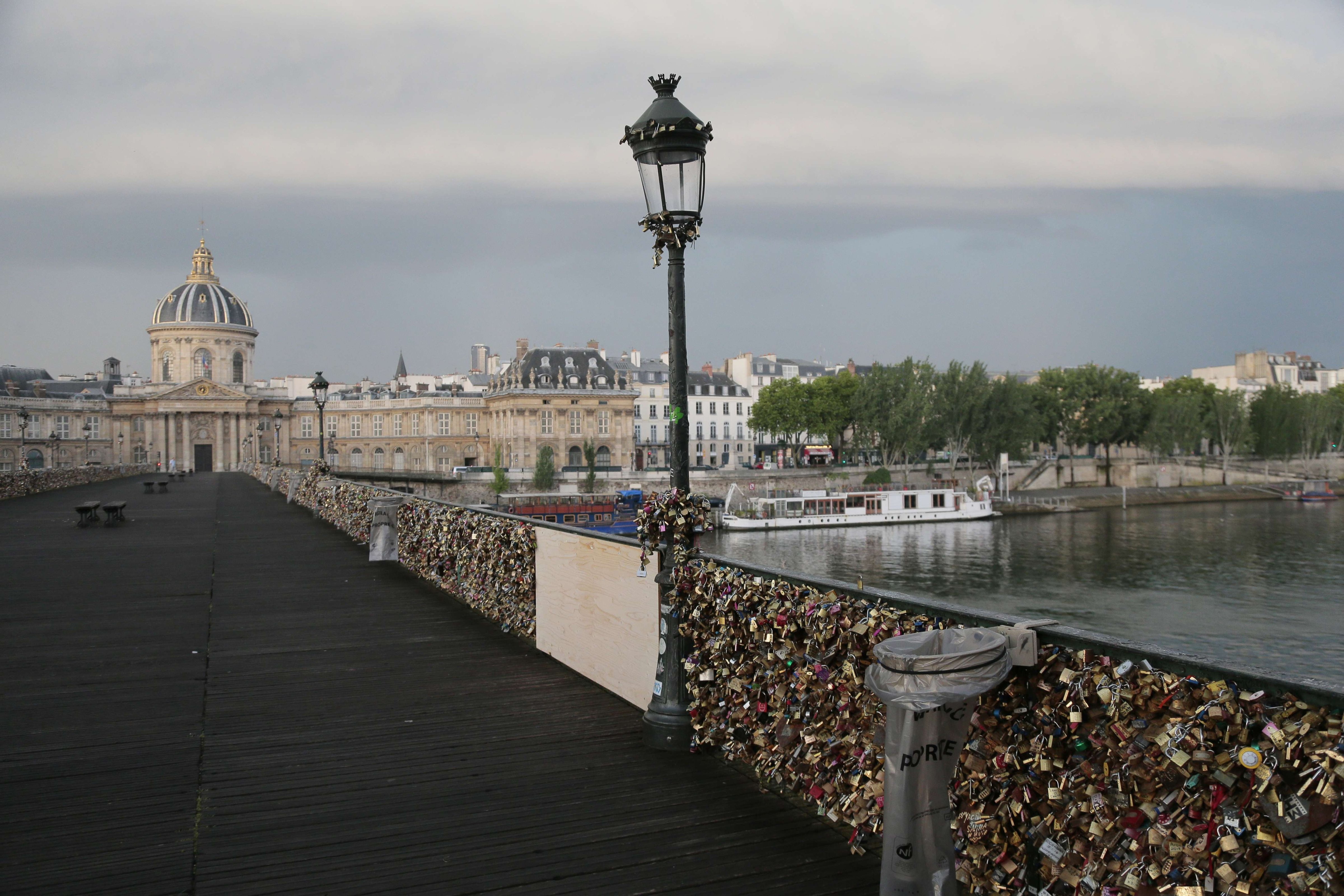 'Love padlocks' attached to a fence of the Pont des Arts bridge over the Seine river in Paris on June 9, 2014.