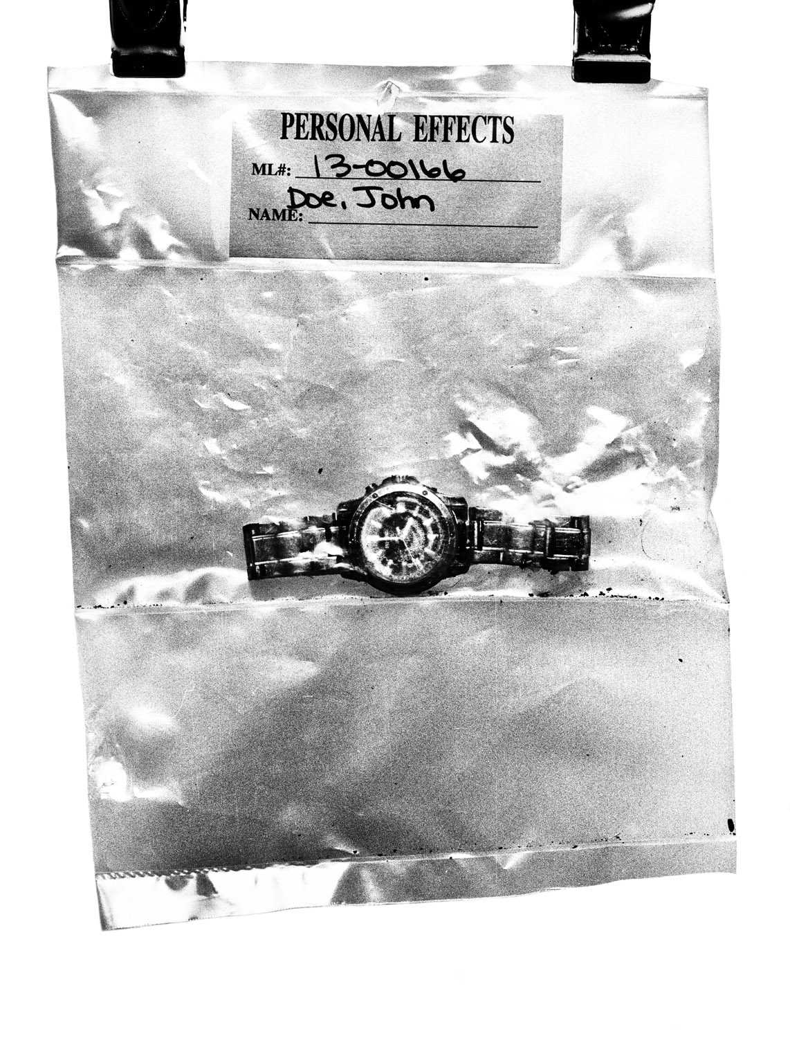 Tucson, Ariz. | 
                              July 30, 2013
                              
                              Personal effects found with migrant remains, like this watch, are cataloged at the Pima County Office of the Medical Examiner in Arizona.
