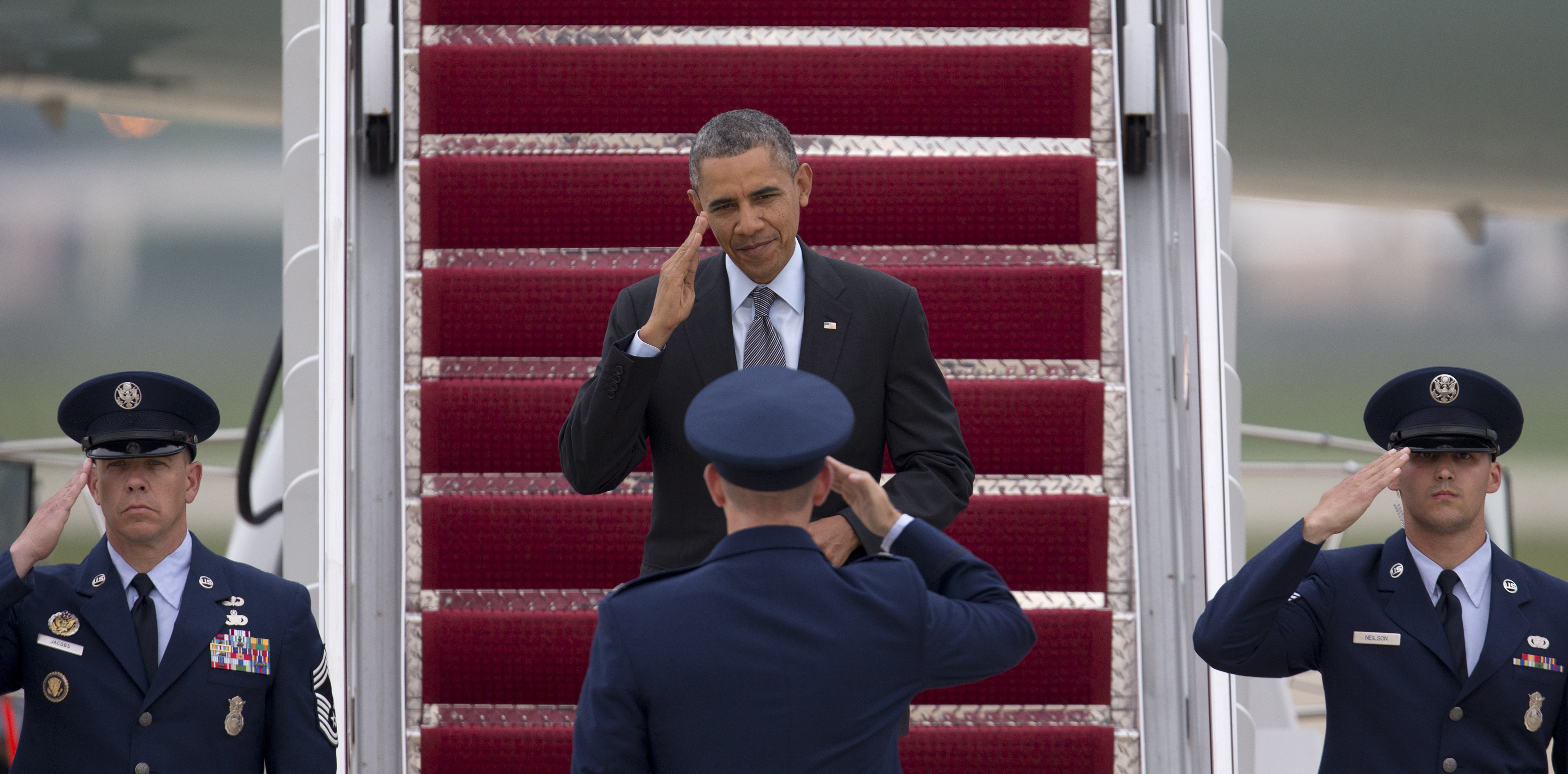 President Barack Obama returns a salute from Col. William M. Knight as he steps off of Air Force One in Andrews Air Force Base, Md, May 9, 2014. (Carolyn Kaster—AP)
