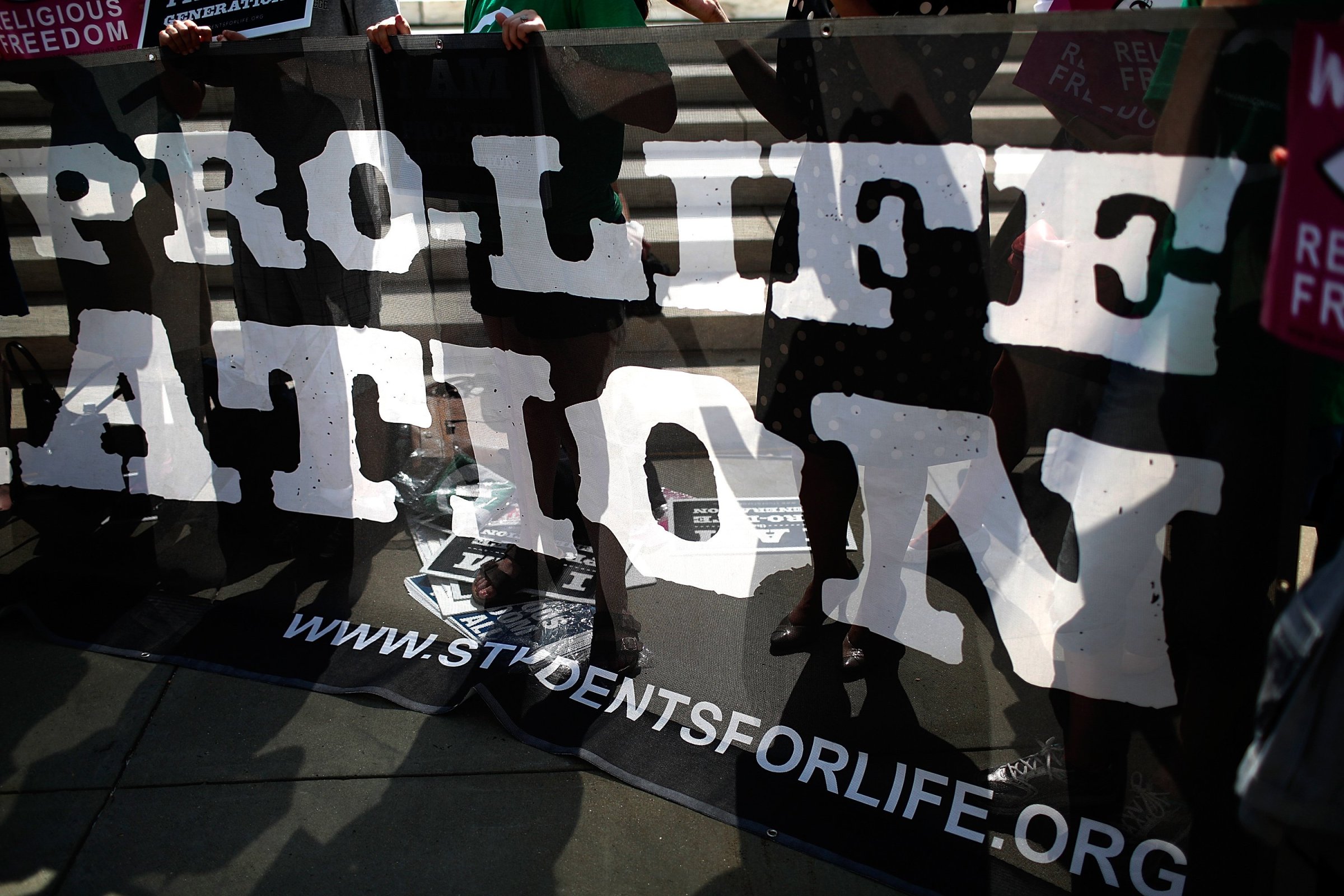 Pro-life activists gather outside the U.S. Supreme Court June 26, 2014 in Washington.