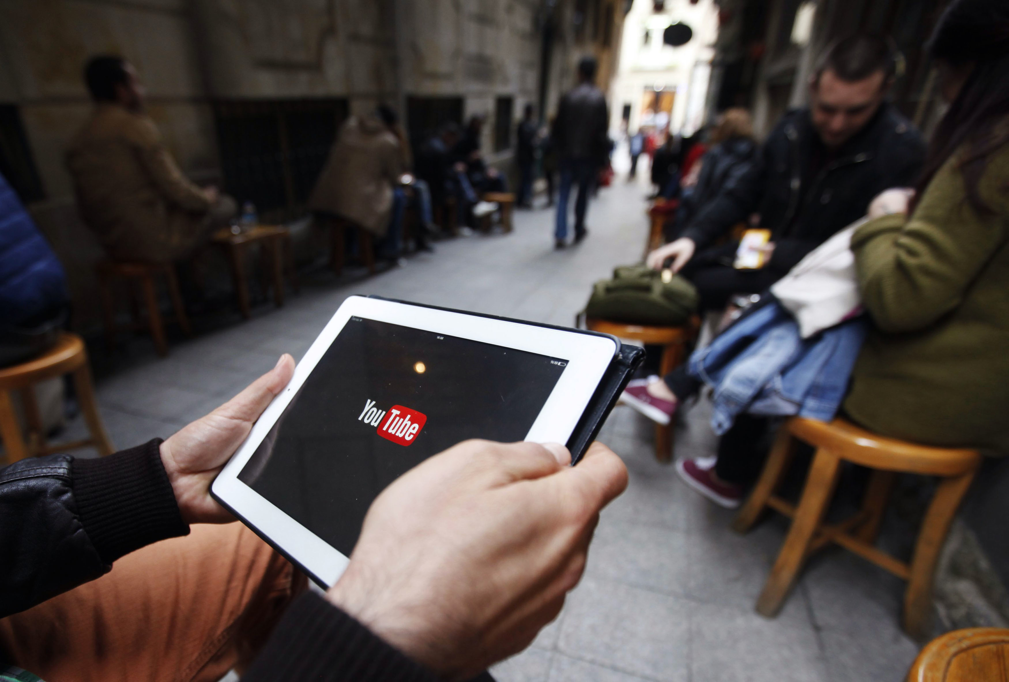 A man tries to connect to YouTube with his tablet at a café in Istanbul on March 27, 2014. (Osman Orsal—Reuters)