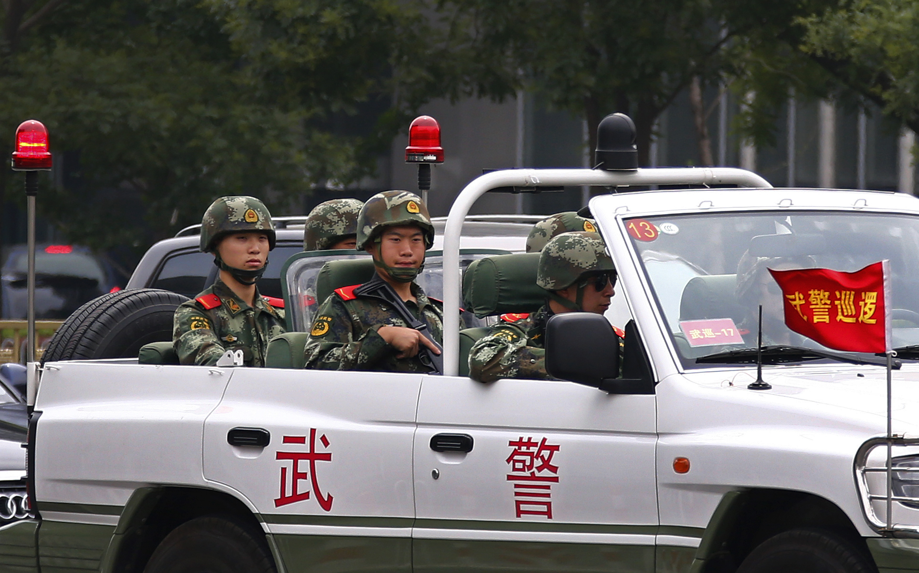 Paramilitary policemen patrol along Chang'an Avenue near Tiananmen Square in Beijing
