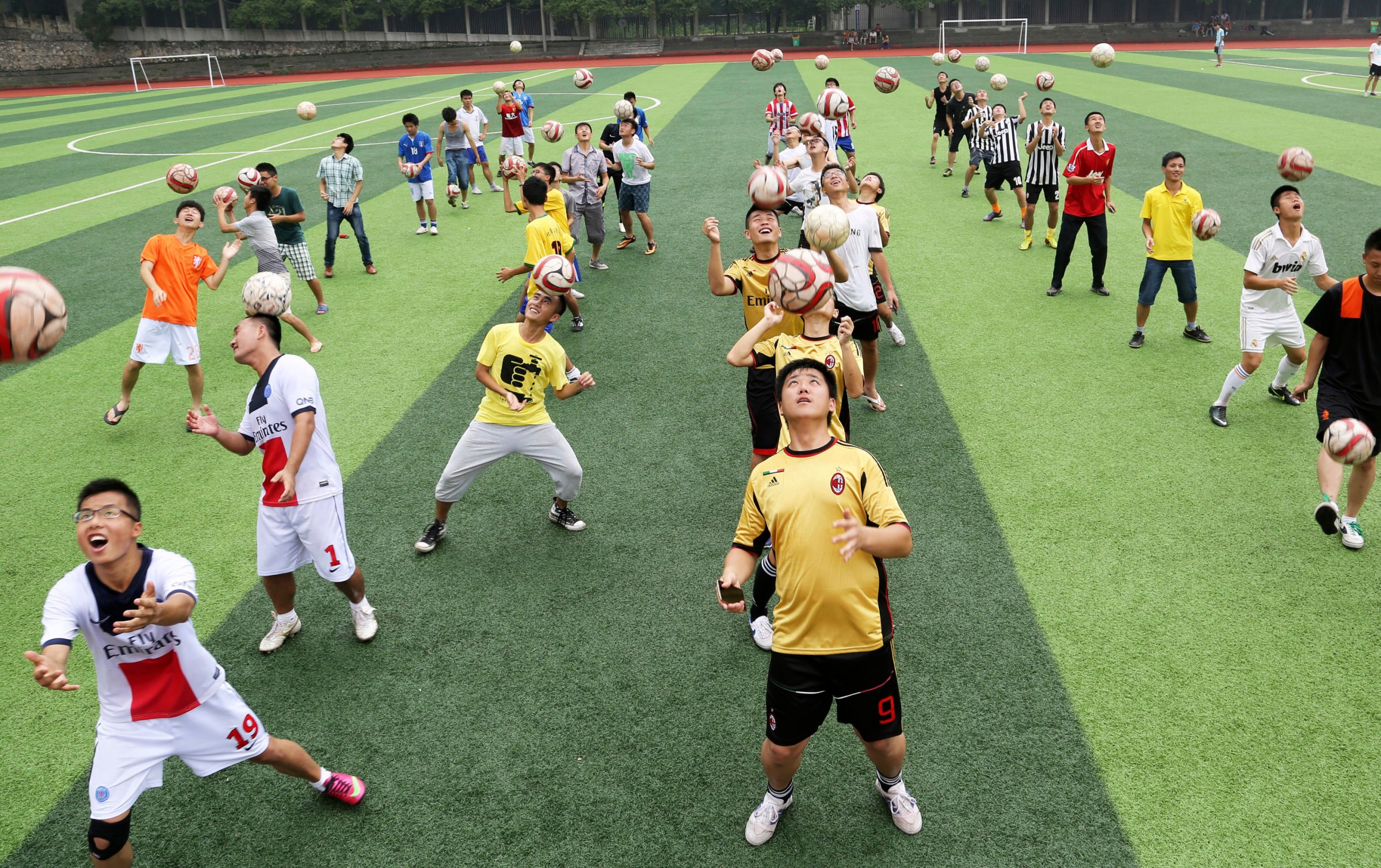 Students head soccer balls during a competition at the campus of University of South China in Hengyang, Hunan province