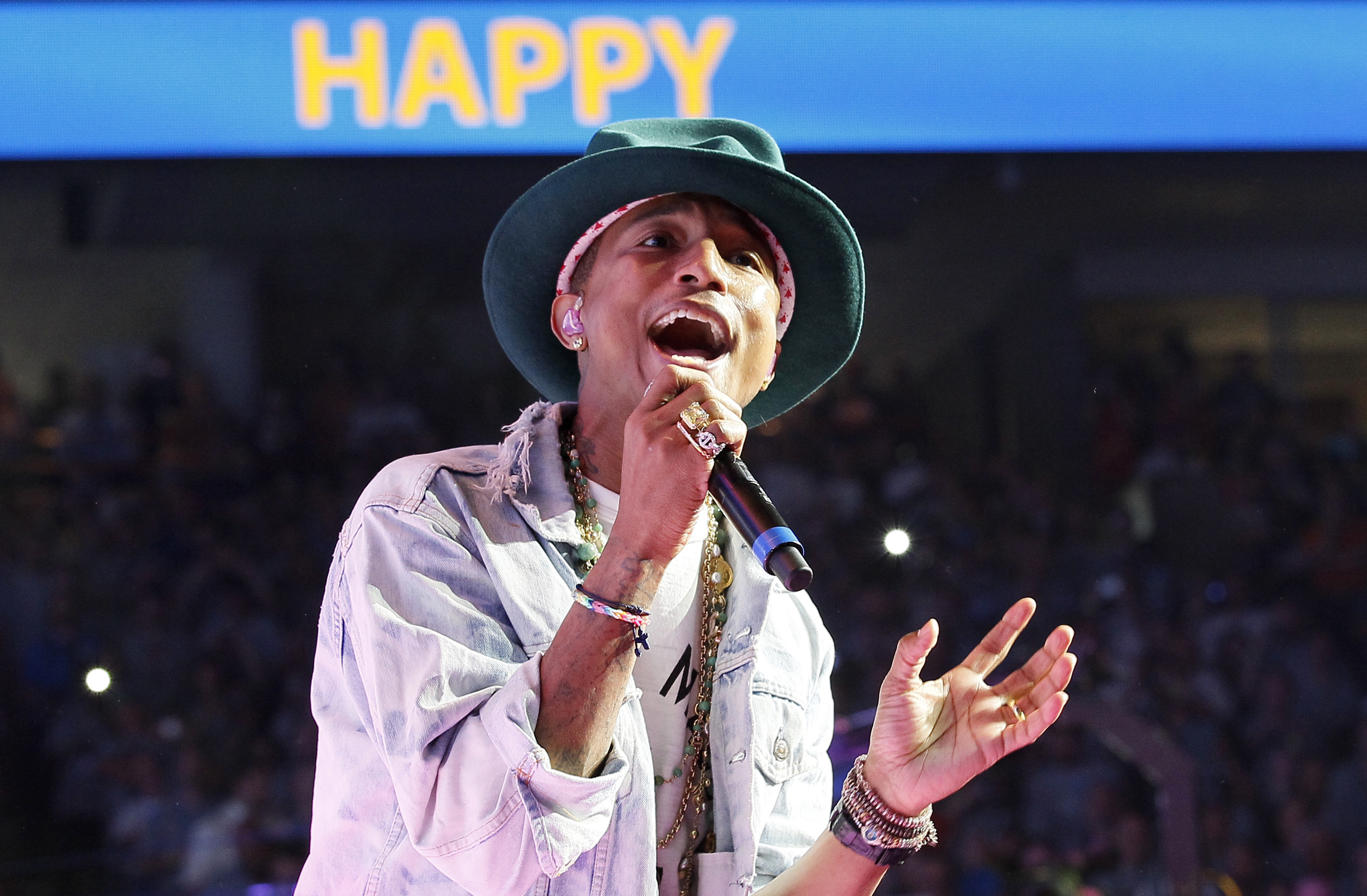 Singer Pharrell Williams performs his hit song "Happy" at the Walmart annual shareholders meeting in Fayetteville