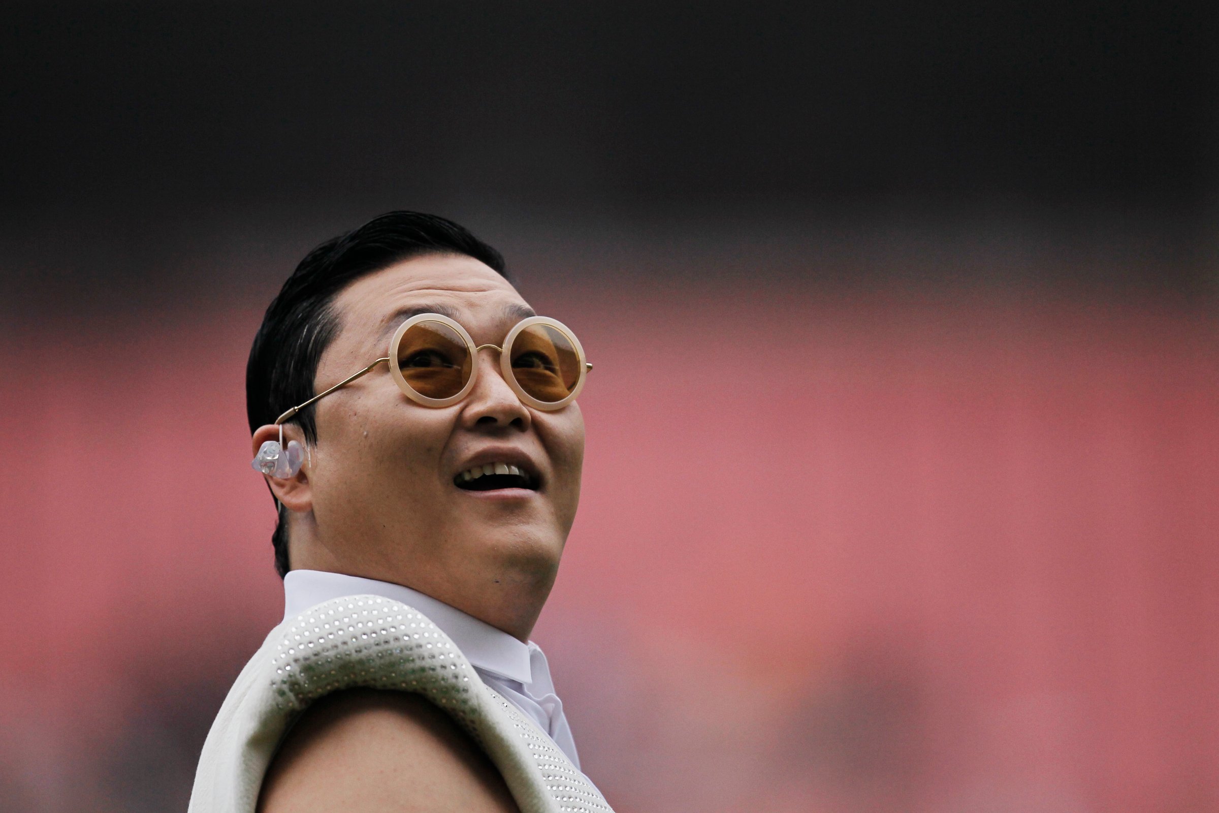 South Korean singer Psy performs during a charity soccer match between the Park Ji-sung and Friends team and Shanghai Laokele Stars in Shanghai