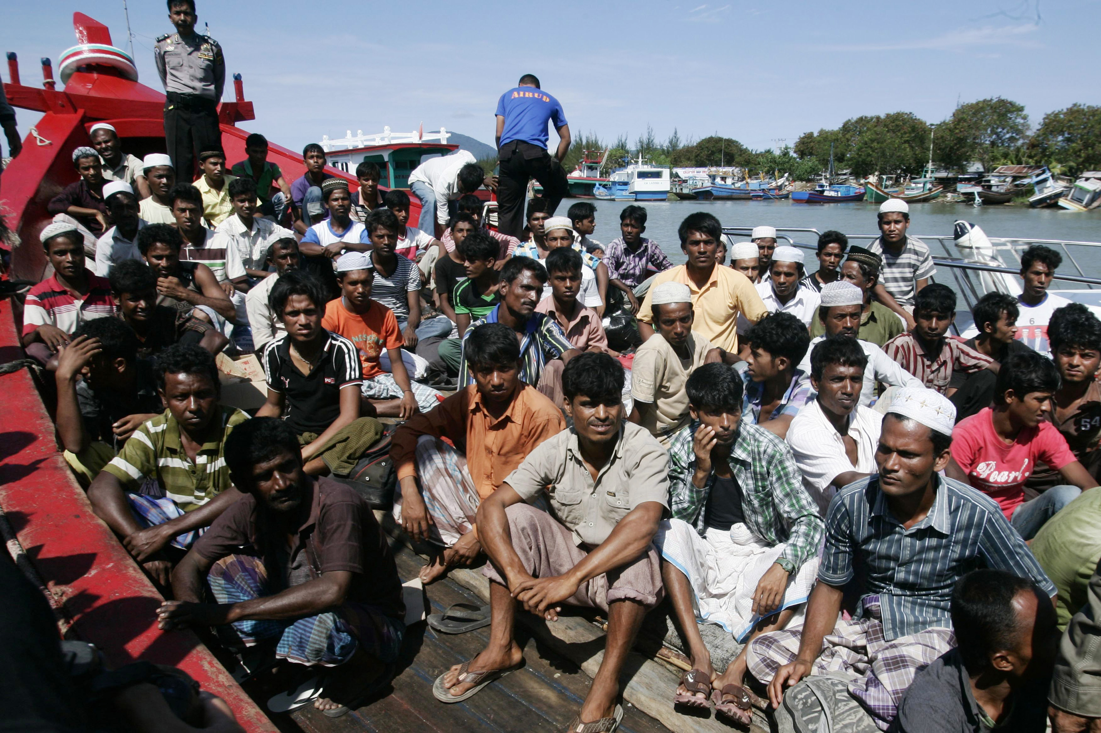 Ethnic Rohingya refugees from Burma sit on a wooden boat as they wait for transportation to a temporary shelter in Aceh Besar after arriving at Lampulo habour April 8, 2013. (Reuters)