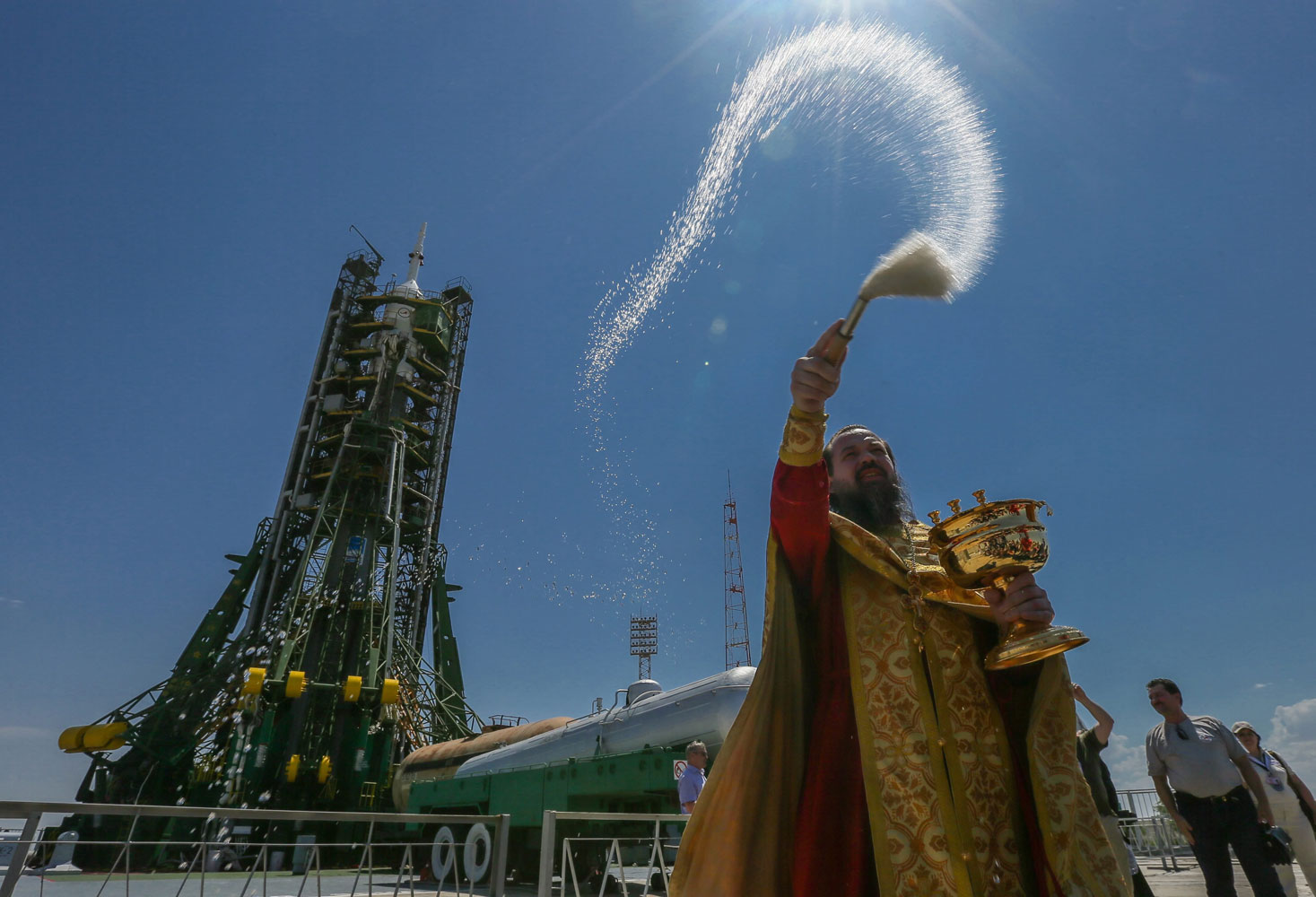 An Orthodox priest blesses the Russian Soyuz TMA-13M rocket booster on the launch pad at the Baikonur Cosmodrome, Kazakhstan, on May 27, 2014.