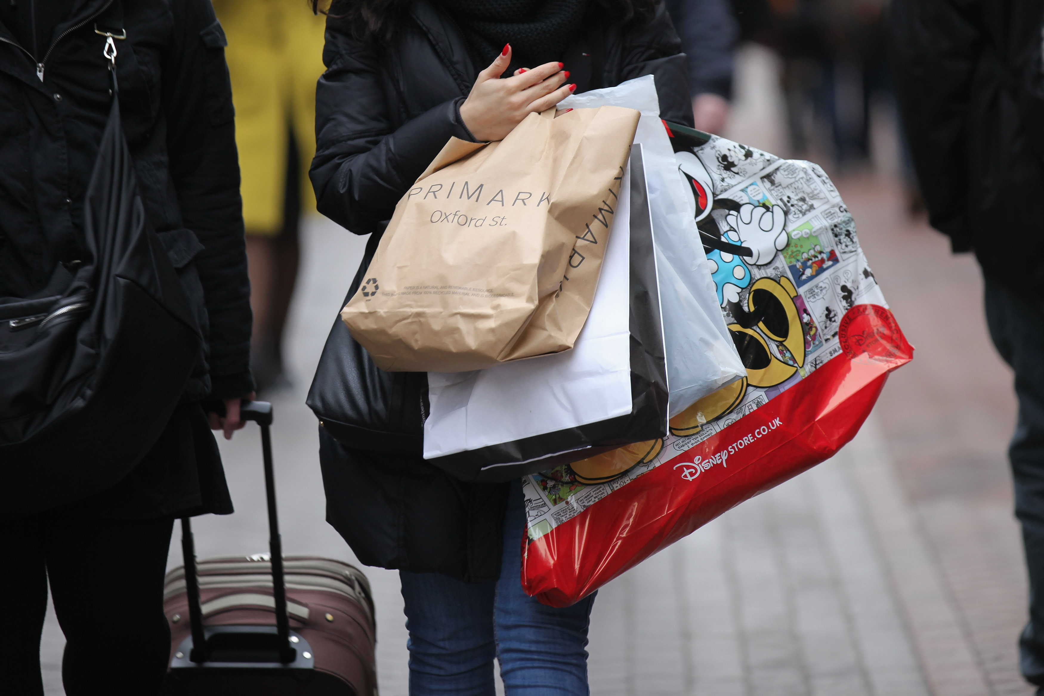 A woman walks along Carnaby Street holding several shopping bags on December 6, 2011in London. (Oli Scarff—Getty Images)