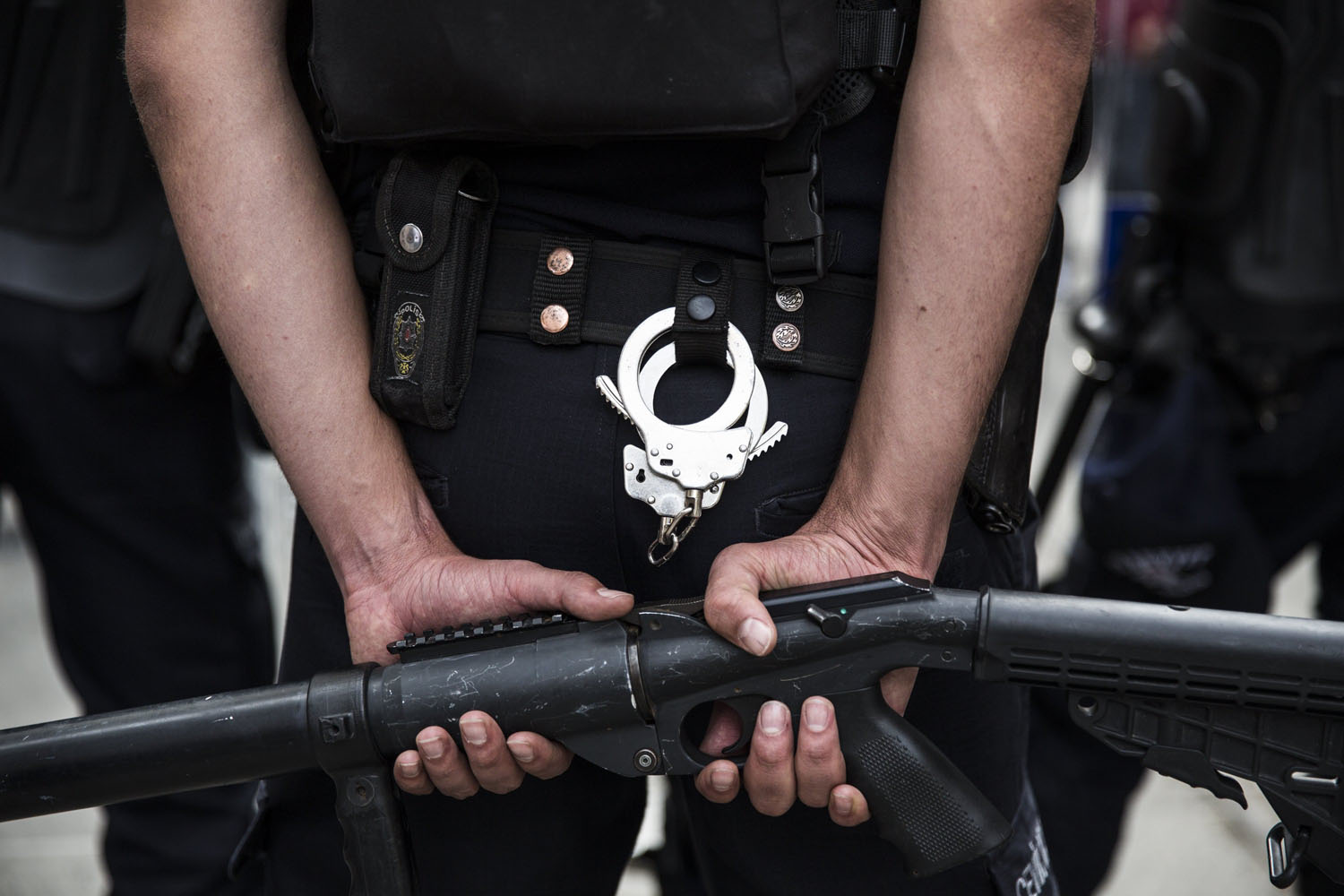 May 31, 2014. A police officer holds a gun used for shooting tear gas at protesters in Istanbul.