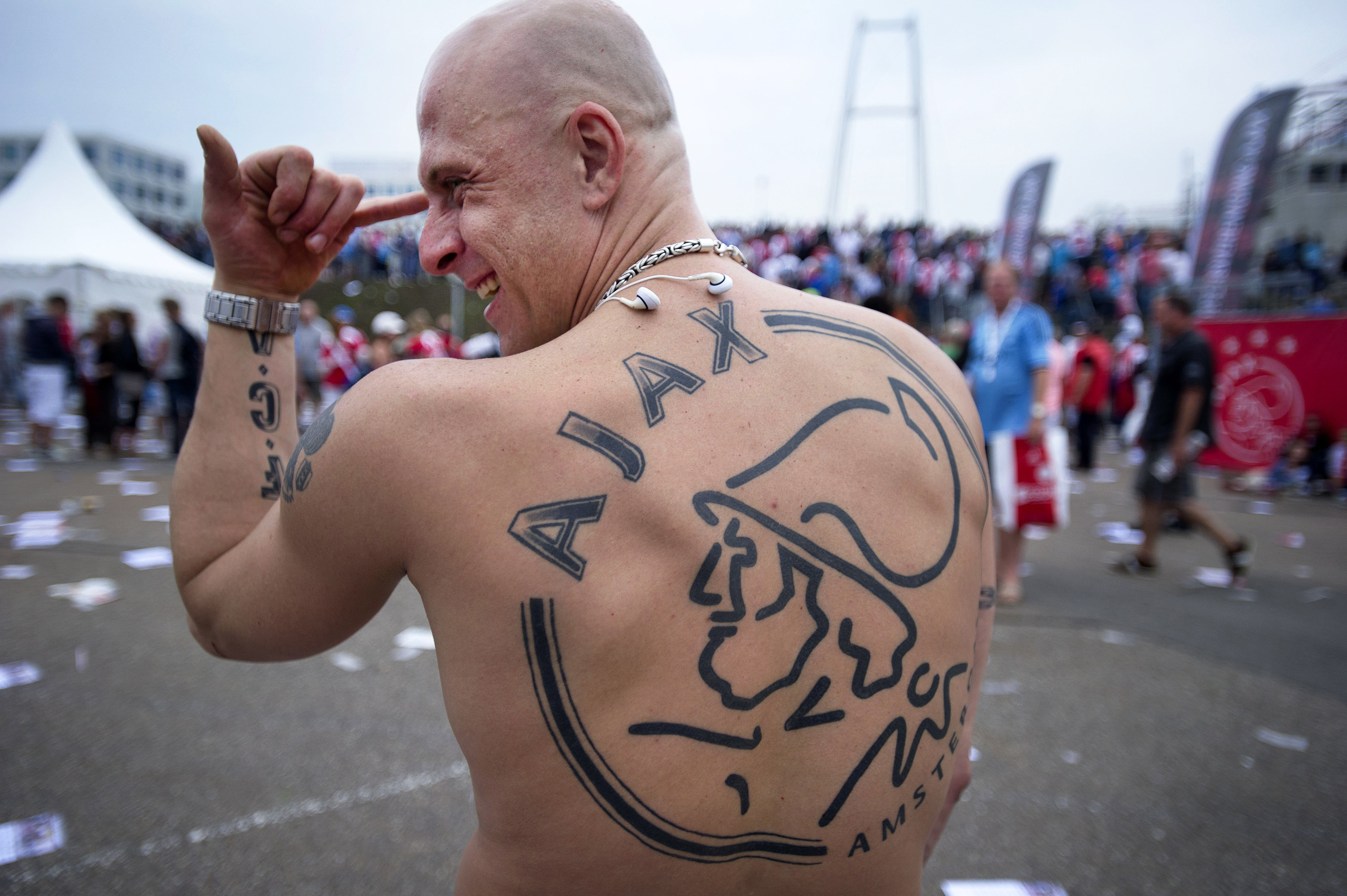 An Ajax soccer fan shows off his tattoo at Amsterdam Arena during the team's opening day on August 3, 2011.