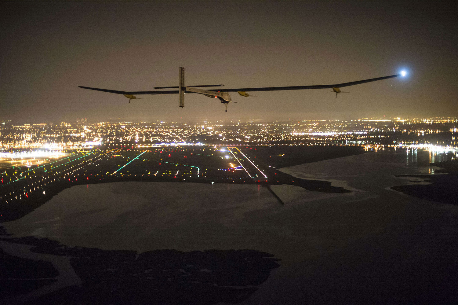 Solar Impulse, with Andre Borschberg onboard, approaches JFK airport on late July 6, 2013 in New York. The experimental Solar Impulse plane, powered by the sun, completed a transcontinental trip across the United States late Saturday, touching down in New York despite a rip in the fabric of one wing.