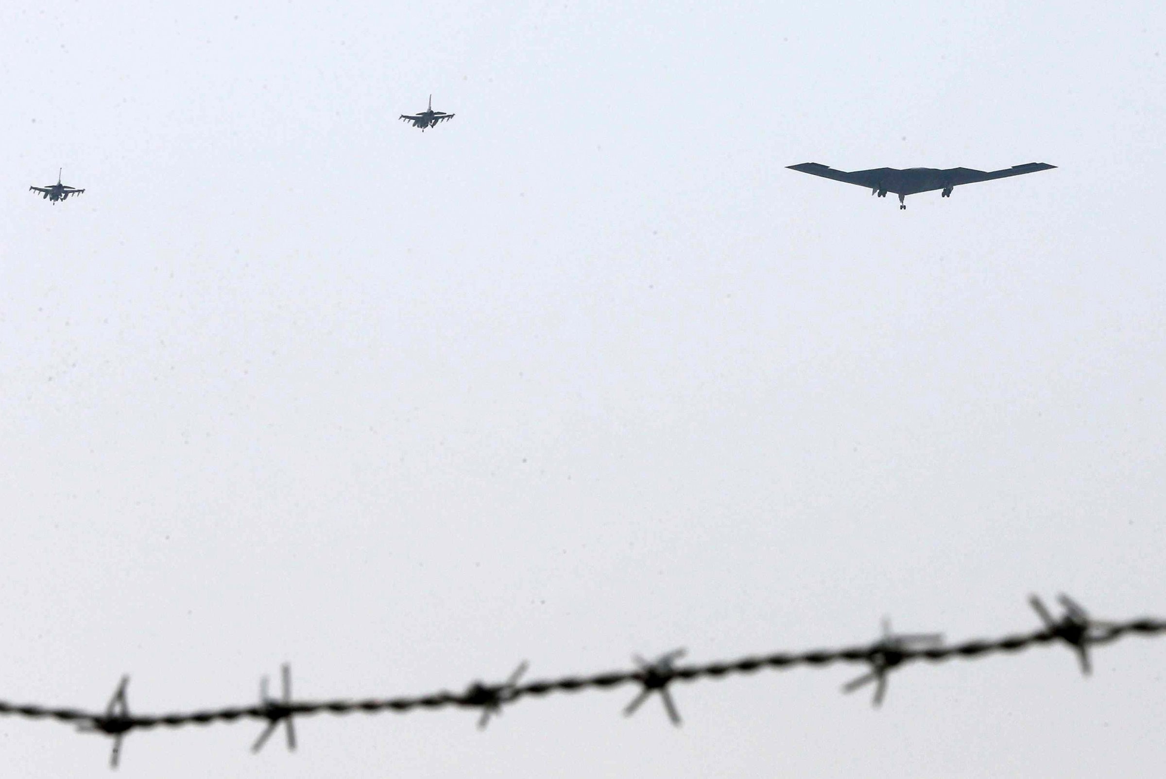 The United States air force's B-2 stealth bomber, center, flies over near the Osan U.S. Air Base in Pyeongtaek, south of Seoul, South Korea, Thursday, March 28, 2013. A day after shutting down a key military hotline, Pyongyang instead used indirect communications with Seoul to allow South Koreans to cross the heavily armed border and work at a factory complex that is the last major symbol of inter-Korean cooperation. (AP Photo/Shin Young-keun, Yonhap) KOREA OUT