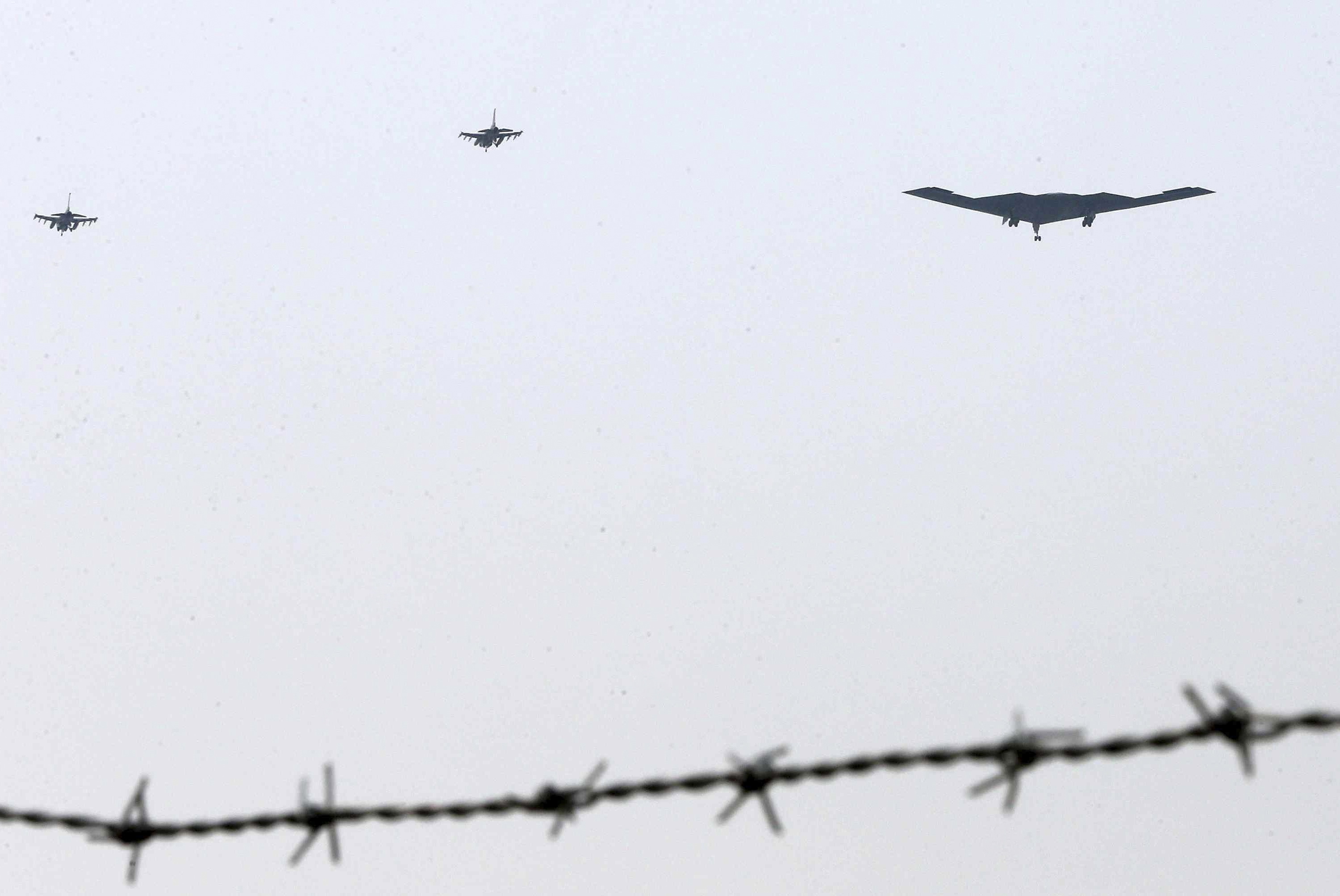 A U.S. B-2 bomber and a pair of F-16s fly over South Korea last year. (Shin Young / AP)