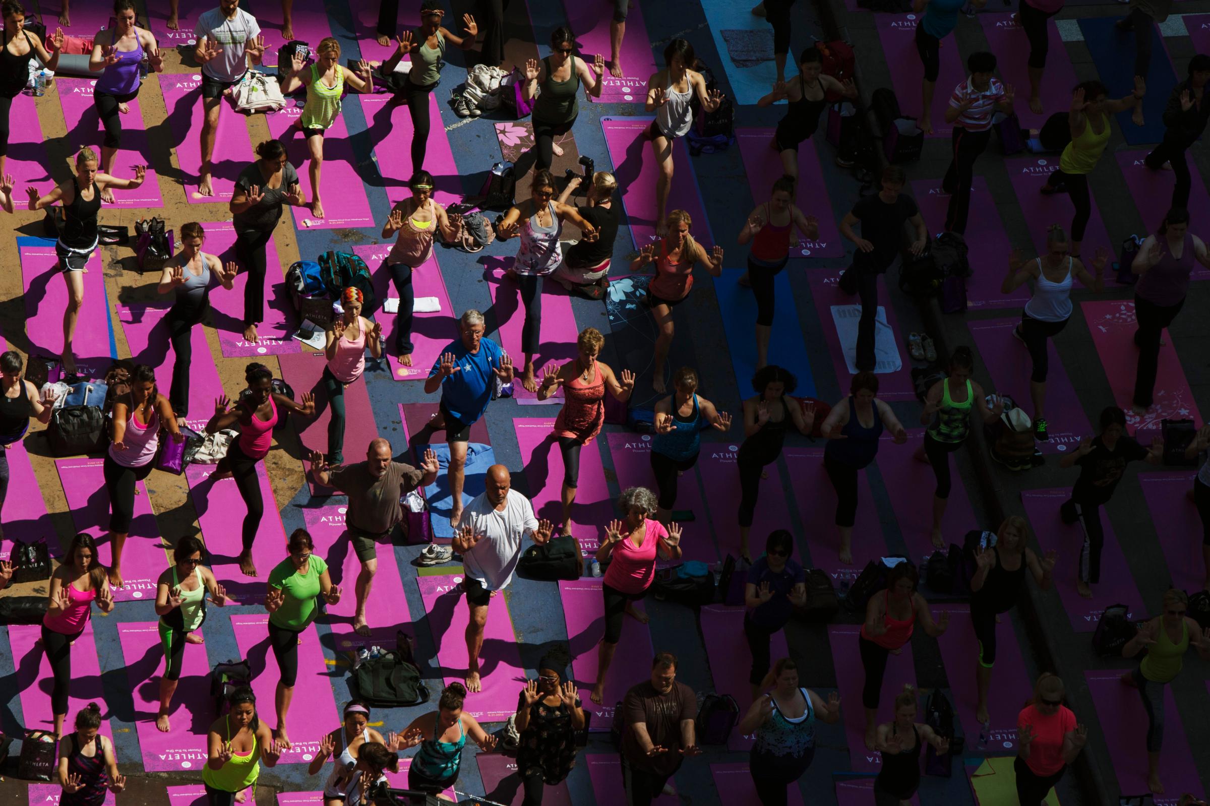 People take part in a group yoga practice on the morning of the summer solstice in New York's Times Square
