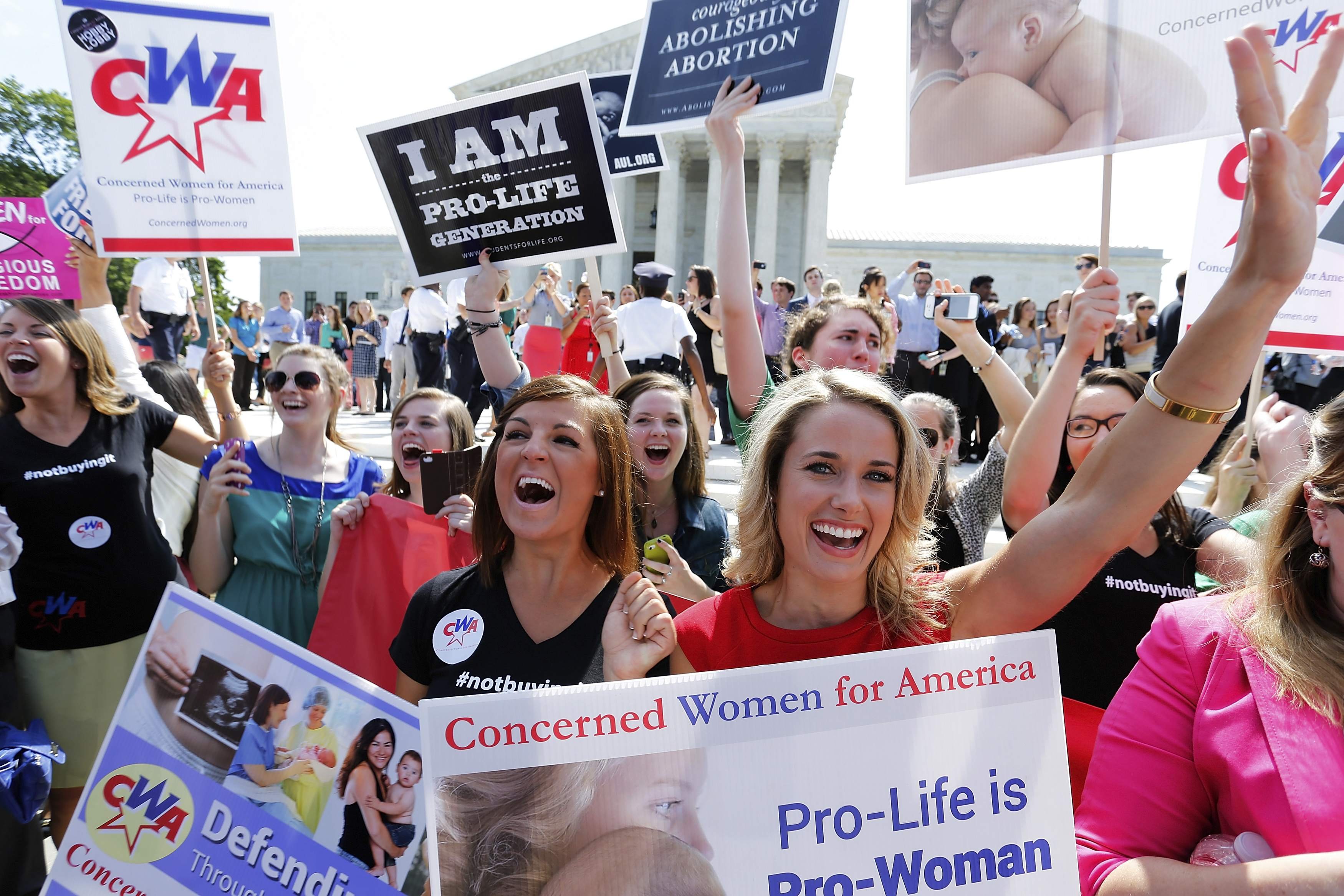 Anti-abortion demonstrators cheer as the ruling for Hobby Lobby was announced outside the U.S. Supreme Court in Washington on June 30, 2014. (Jonathan Ernst—Reuters)