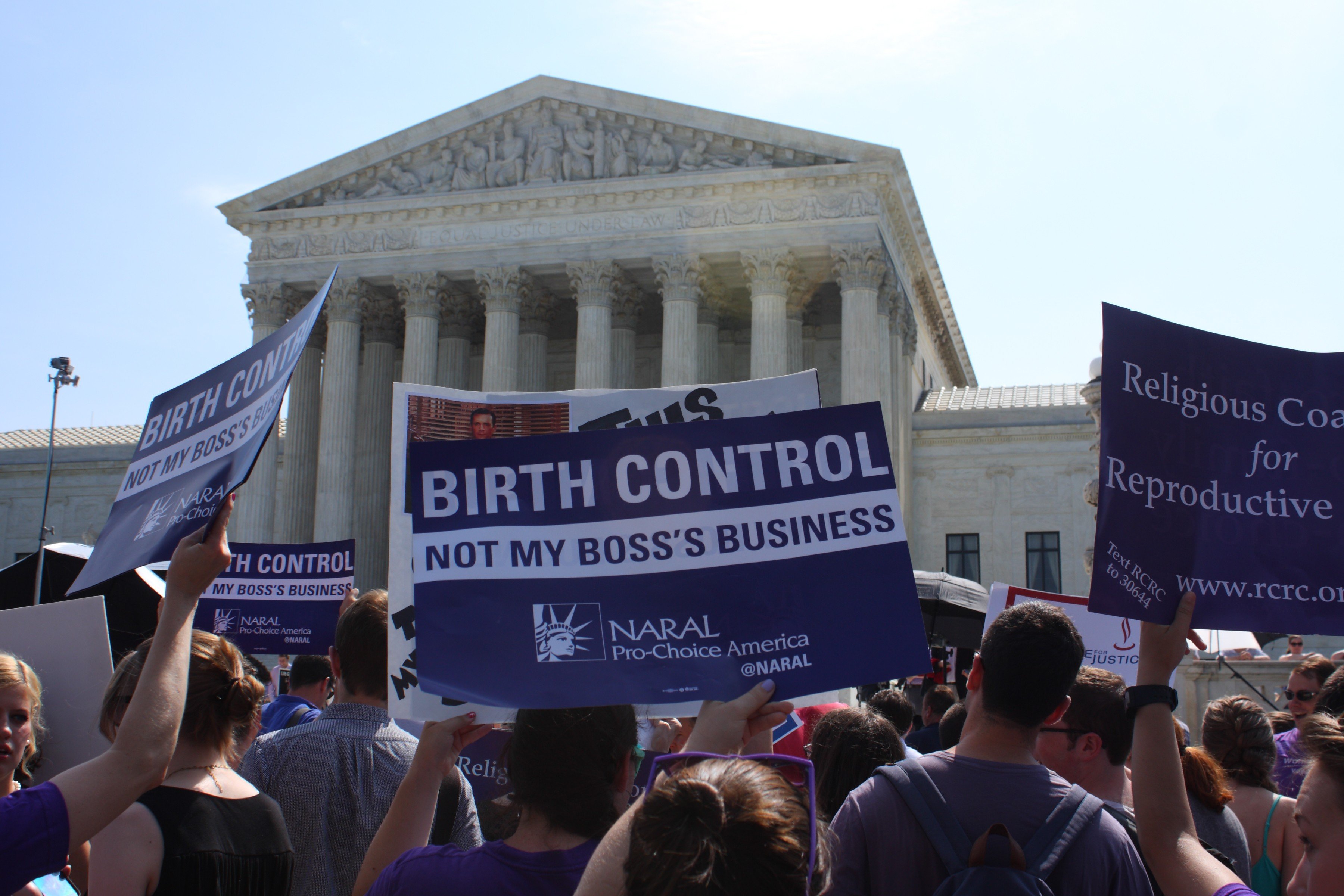 People with signs outside the Supreme Court building await a ruling in Burwell v. Hobby Lobby on June 30, 2014 in Washington. (Evan Golub—Demotix/Corbis)