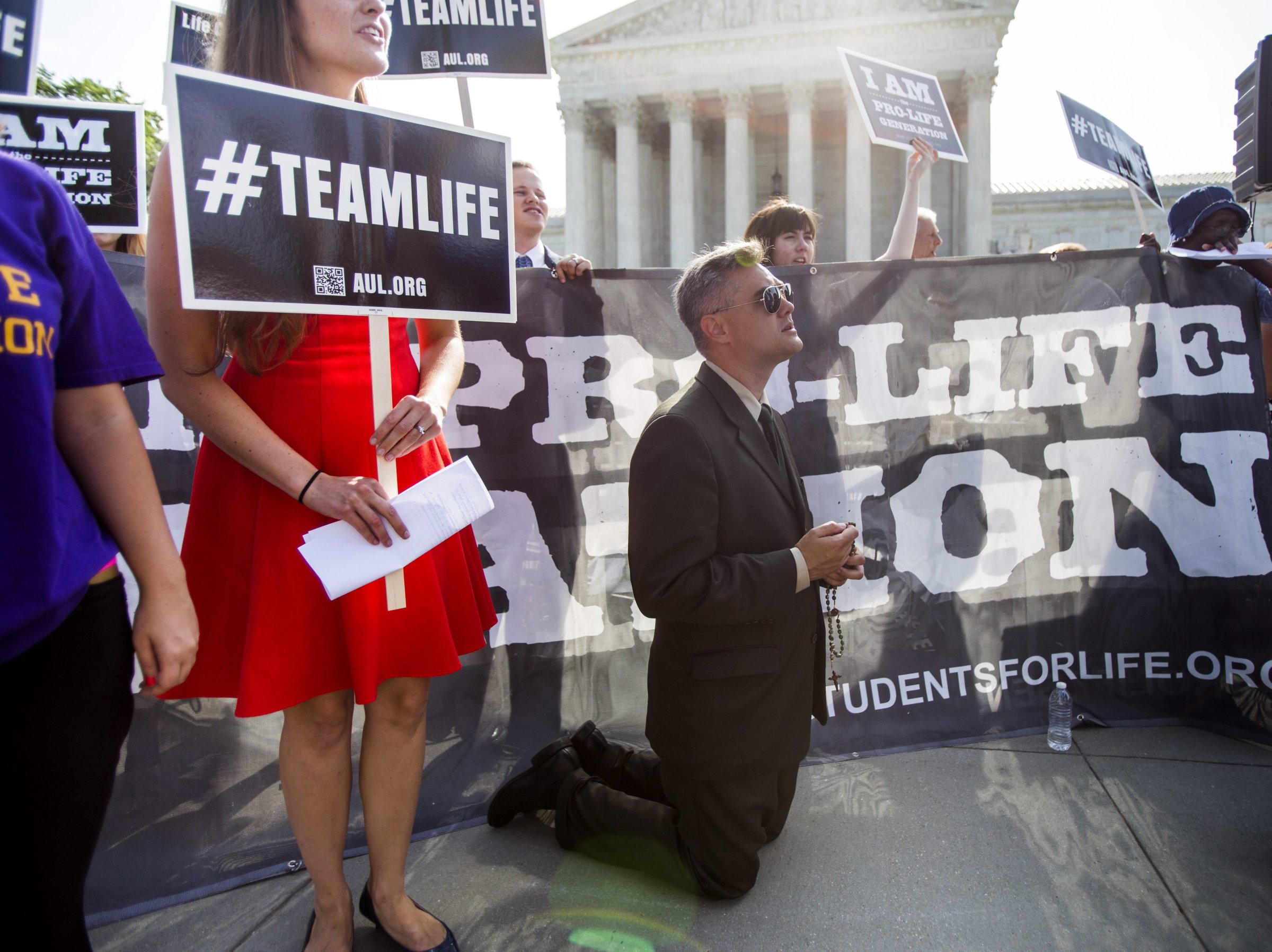 Pro-life supporter Michael Hichborn with American Life League prays outside the US Supreme Court where the nine justices are expected to issue their ruling on the Hobby Lobby case, which challenges the Affordable Care ActÕs mandate that employee health plans include pregnancy preventive services, in Washington on June 30, 2014.