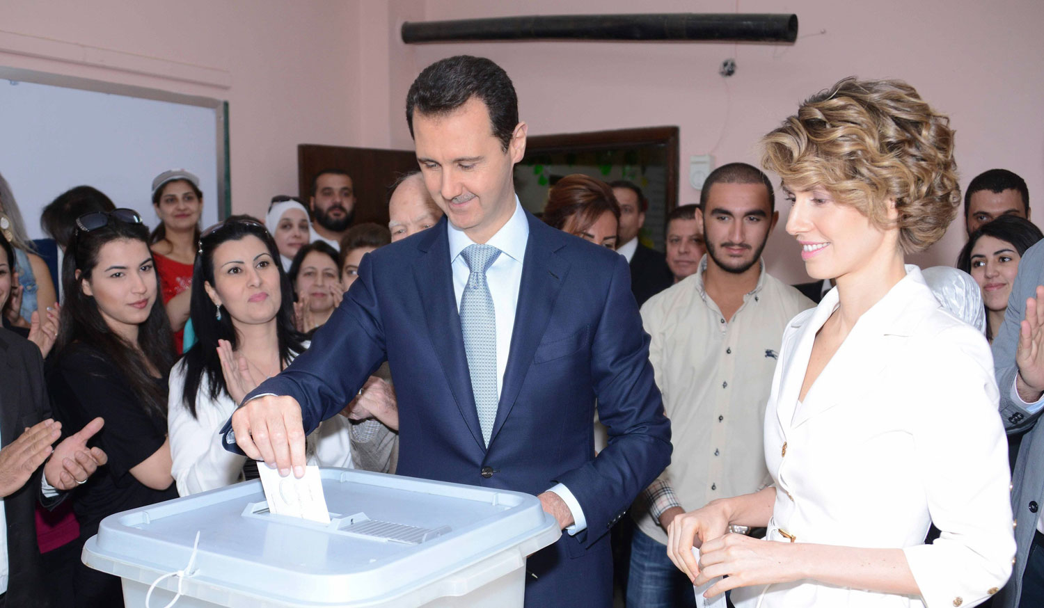 Syria's President Bashar al-Assad and his wife Asma cast their votes at a polling station in Damascus June 3, 2014.