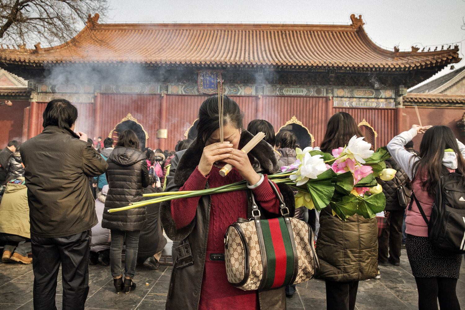Han Chinese devotees offer incense at the Lama Tibetan Buddhist temple in Beijing on a Sunday morning earlier this year (Sim Chi Yin— VII Mentor Program for TIME)