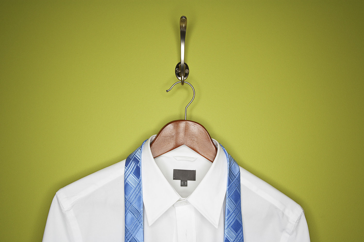 Stock image of a dress shirt and tie on hanger