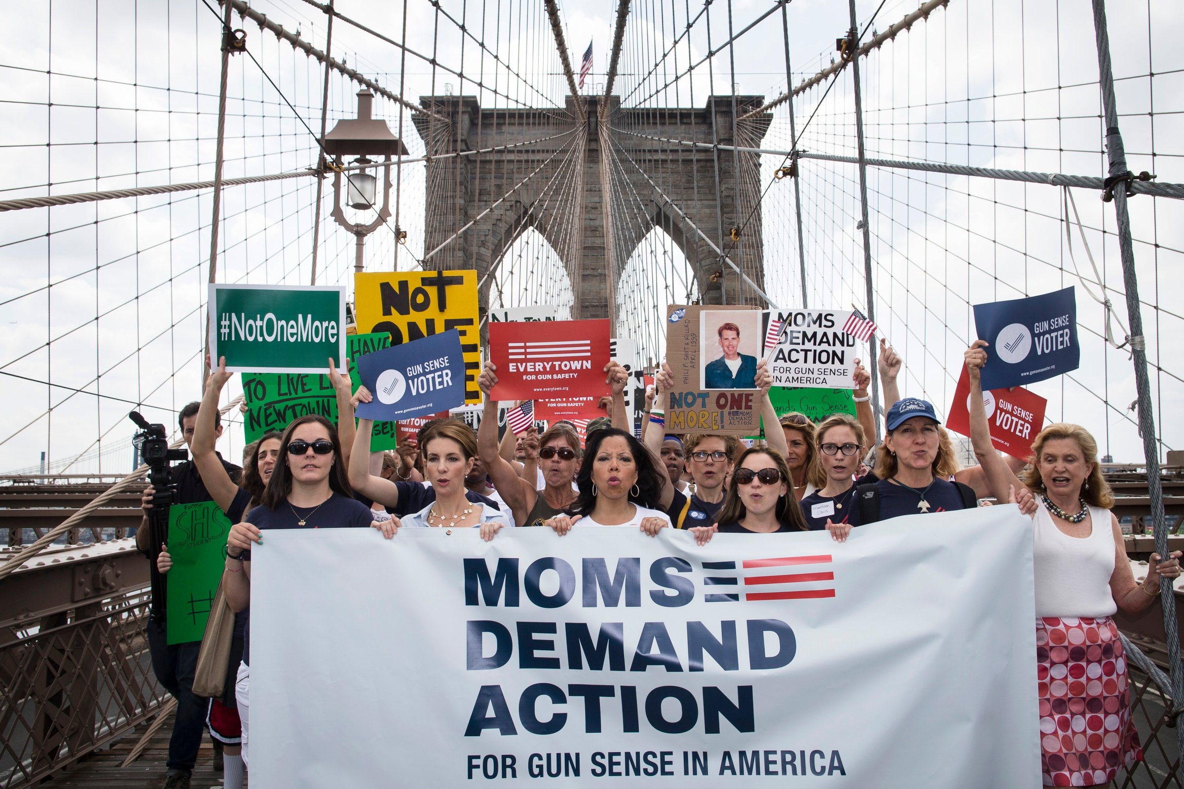 Hundreds of demonstrators march across the Brooklyn Bridge to call for tougher gun control laws, Saturday, June 14, 2014, in New York.