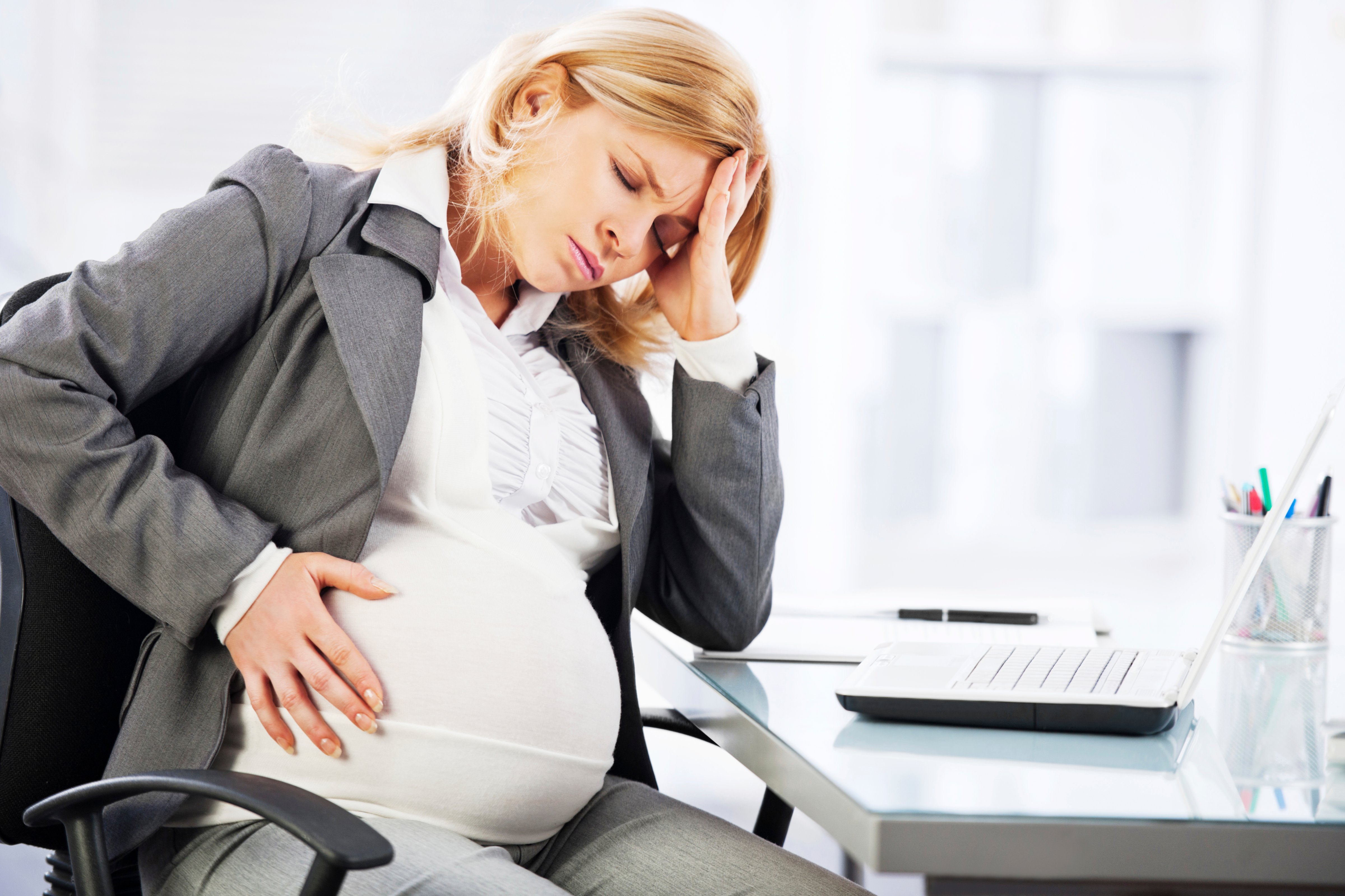 A pregnant working woman is shown. (Kristian Sekulic—Getty Images)