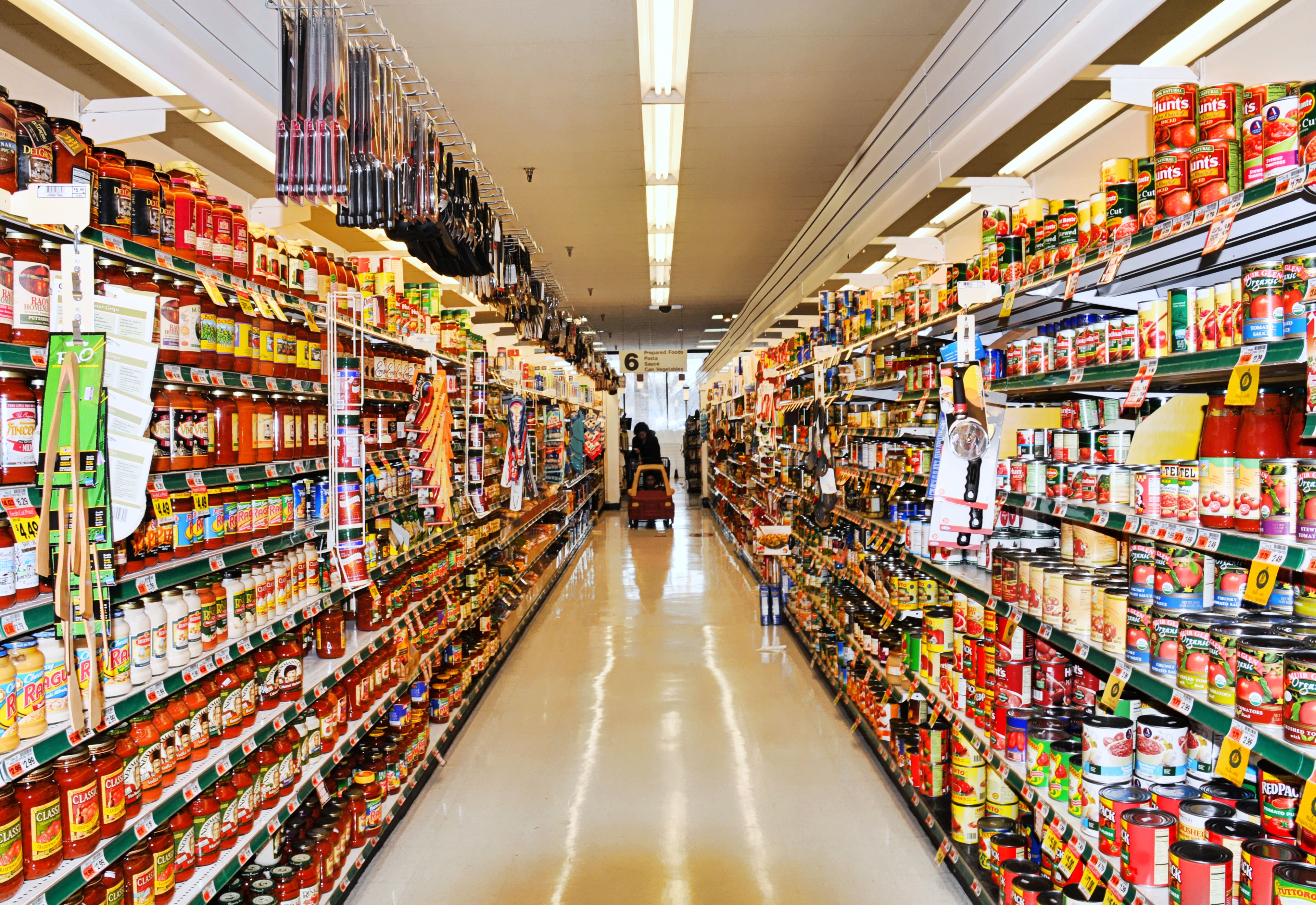 Aisle at supermarket with shopper and shopping cart (Diana Angstadt—FlickrVision)